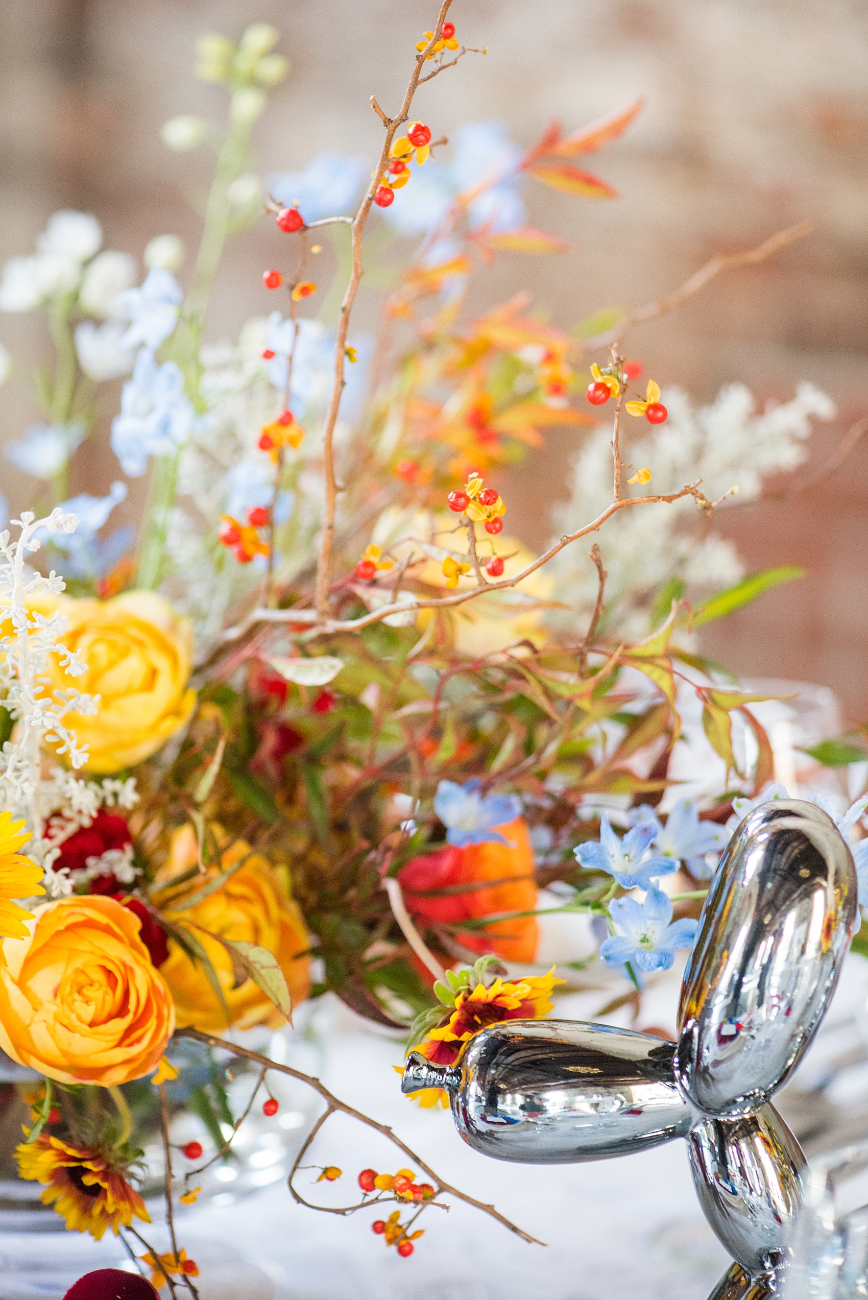 Mikkel Paige Photography photos of a wedding at the Green Building in Brooklyn, New York. This same sex, gay marriage styled shoot was created by Color Pop Events. The urban dinner table was styled by Taylor and Hov, inspired by Jeff Koons and neo pop art. Flower centerpieces are by Abby Tabak Studio.