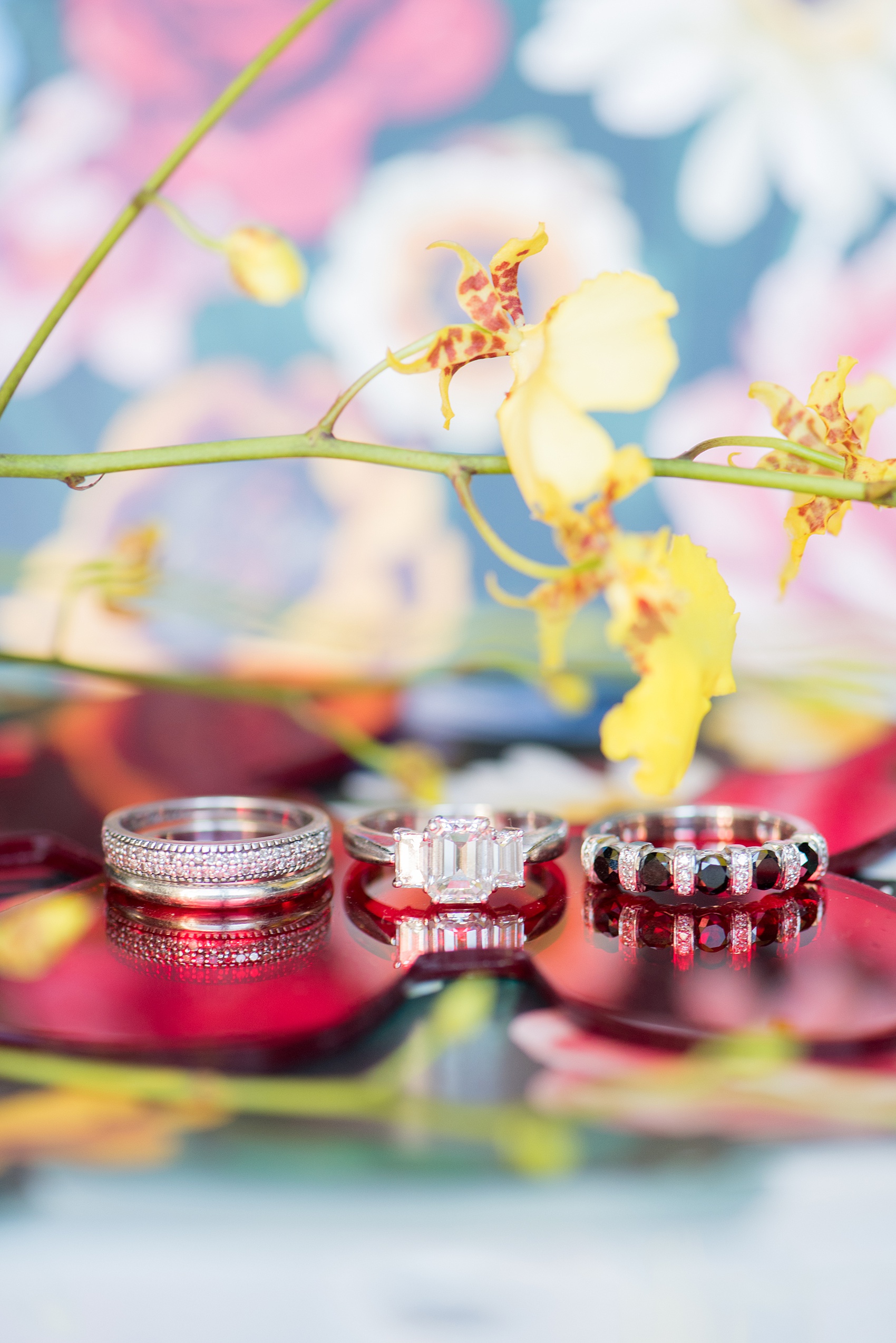 Mikkel Paige Photography photos of a wedding at the Green Building in Brooklyn, New York. This same sex, gay marriage styled shoot was created by Color Pop Events. This detail picture shows the bride's ring was black and white diamonds with an emerald cut engagement ring. Flowers by Abby Tabak Studio.