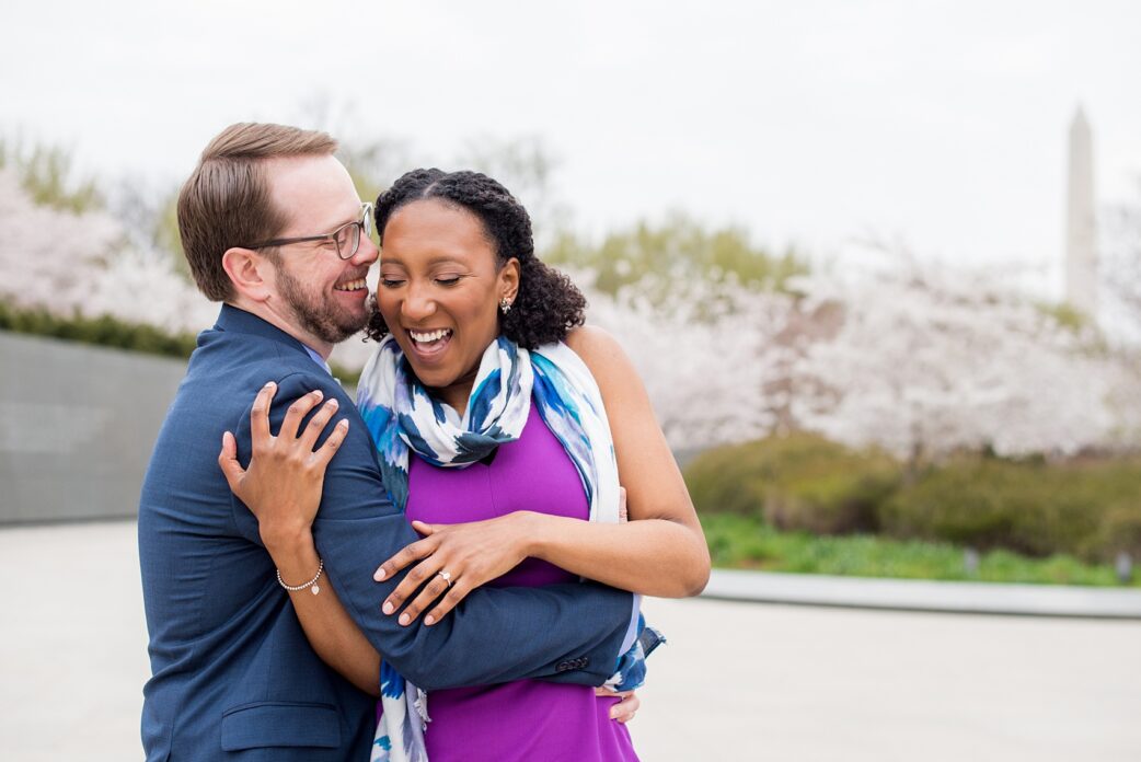 DC Cherry Blossoms Engagement Photos by Mikkel Paige Photography. Spring flowers around the MLK memorial and Tidal Basin at the nation's Capitol for a beautiful, interracial couple.