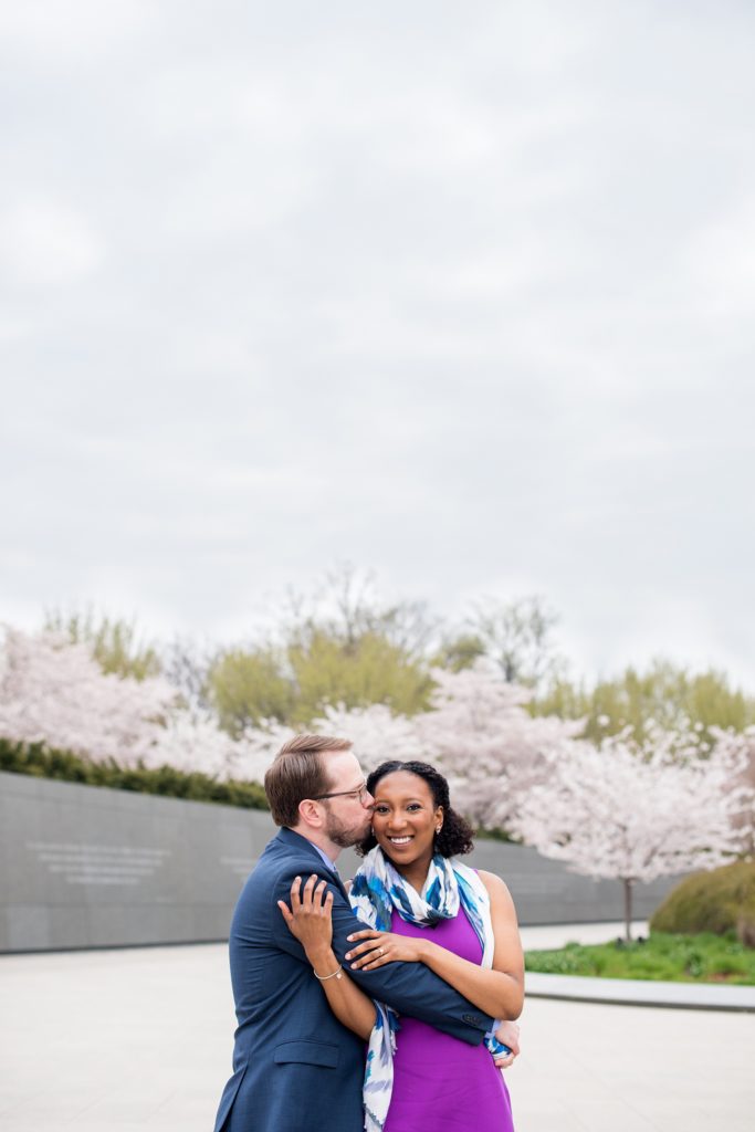 DC Cherry Blossoms Engagement Photos by Mikkel Paige Photography. Spring flowers around the MLK memorial and Tidal Basin at the nation's Capitol with an interracial couple. #DCCherryBlossoms #CherryBlossoms #EngagementPhotos #SpringEngagementPhotos #CherryBlossomsEngagementPhotos