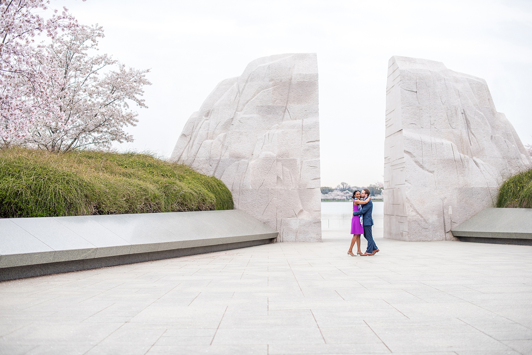 DC Cherry Blossoms Engagement Photos by Mikkel Paige Photography. Spring flowers around the MLK memorial and Tidal Basin at the nation's Capitol with an interracial couple. #DCCherryBlossoms #CherryBlossoms #EngagementPhotos #SpringEngagementPhotos #CherryBlossomsEngagementPhotos