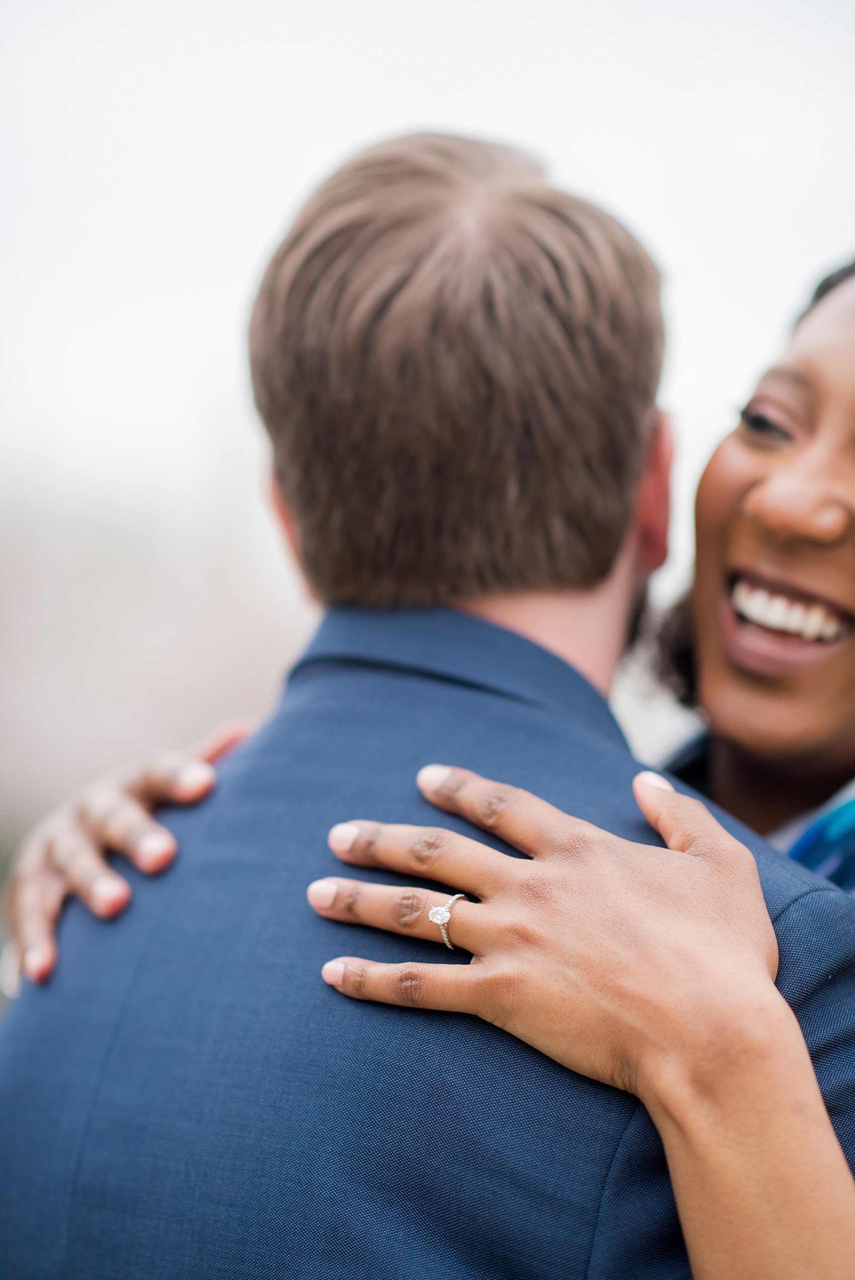 DC Cherry Blossoms Engagement Photos by Mikkel Paige Photography. Spring flowers around the MLK memorial and Tidal Basin at the nation's Capitol with an interracial couple. #DCCherryBlossoms #CherryBlossoms #EngagementPhotos #SpringEngagementPhotos #CherryBlossomsEngagementPhotos