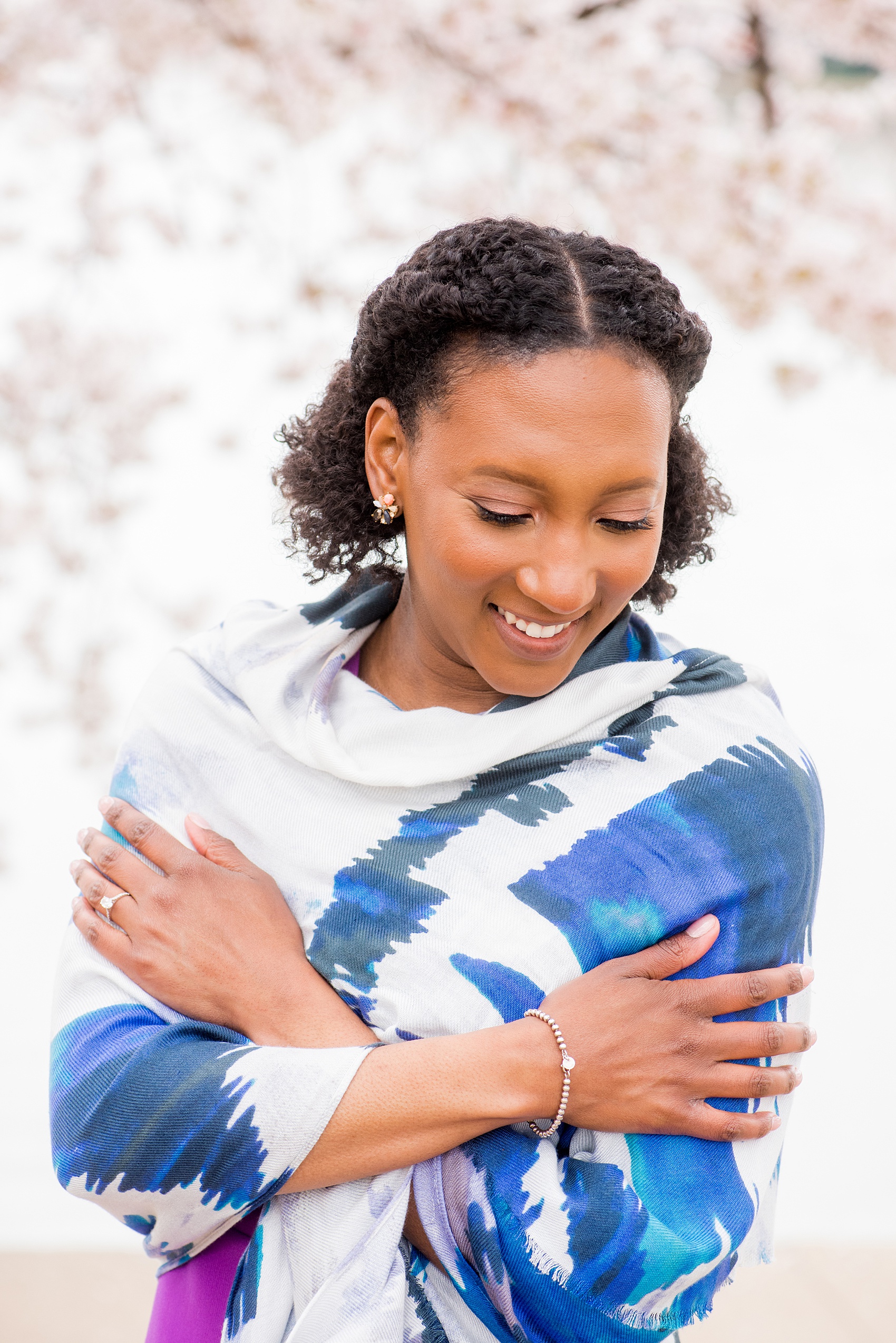 DC Cherry Blossoms Engagement Photos by Mikkel Paige Photography. Spring flowers around the MLK memorial and Tidal Basin at the nation's Capitol with an African American bride in a colorful outfit. #DCCherryBlossoms #CherryBlossoms #EngagementPhotos #SpringEngagementPhotos #CherryBlossomsEngagementPhotos