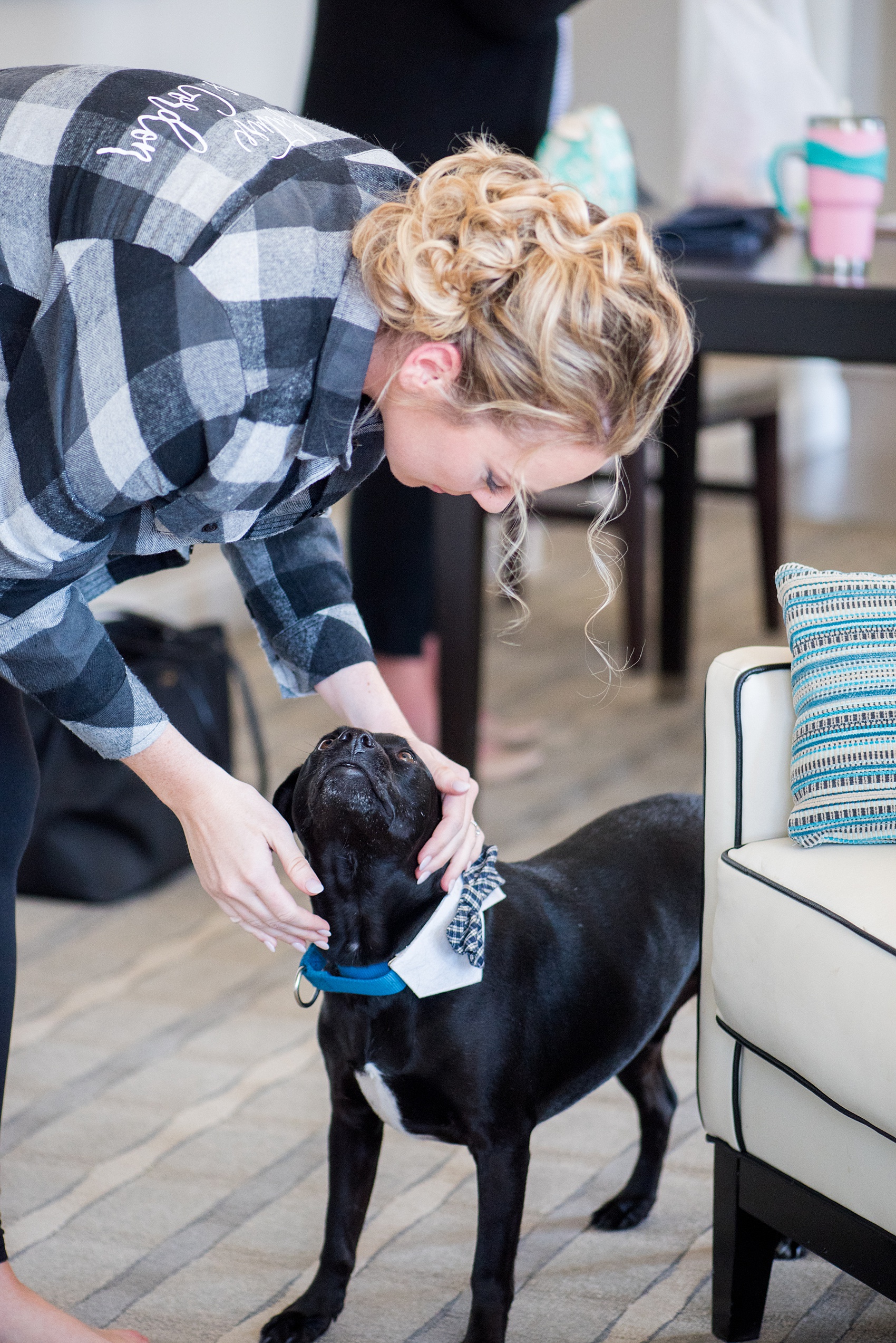 Saratoga Springs destination wedding photos by Mikkel Paige Photography. The bride wore a custom grey, black and white plaid button down "Mrs" shirt at The Pavilion Grand hotel during getting ready photos, with her dog by her side. The spring reception was held at Saratoga National Golf Club venue. #SaratogaSpringsNY #SaratogaSprings #mikkelpaige #NYwedding #destinationwedding 