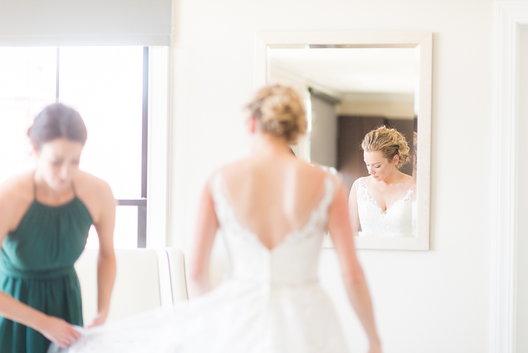 Saratoga Springs destination wedding photos by Mikkel Paige Photography. The bride got ready at the Pavilion Grand hotel and wore a lace gown that her sister and Maid of Honor helped her get ready in. The spring reception was held at Saratoga National Golf Club venue. #SaratogaSpringsNY #SaratogaSprings #mikkelpaige #NYwedding #destinationwedding 