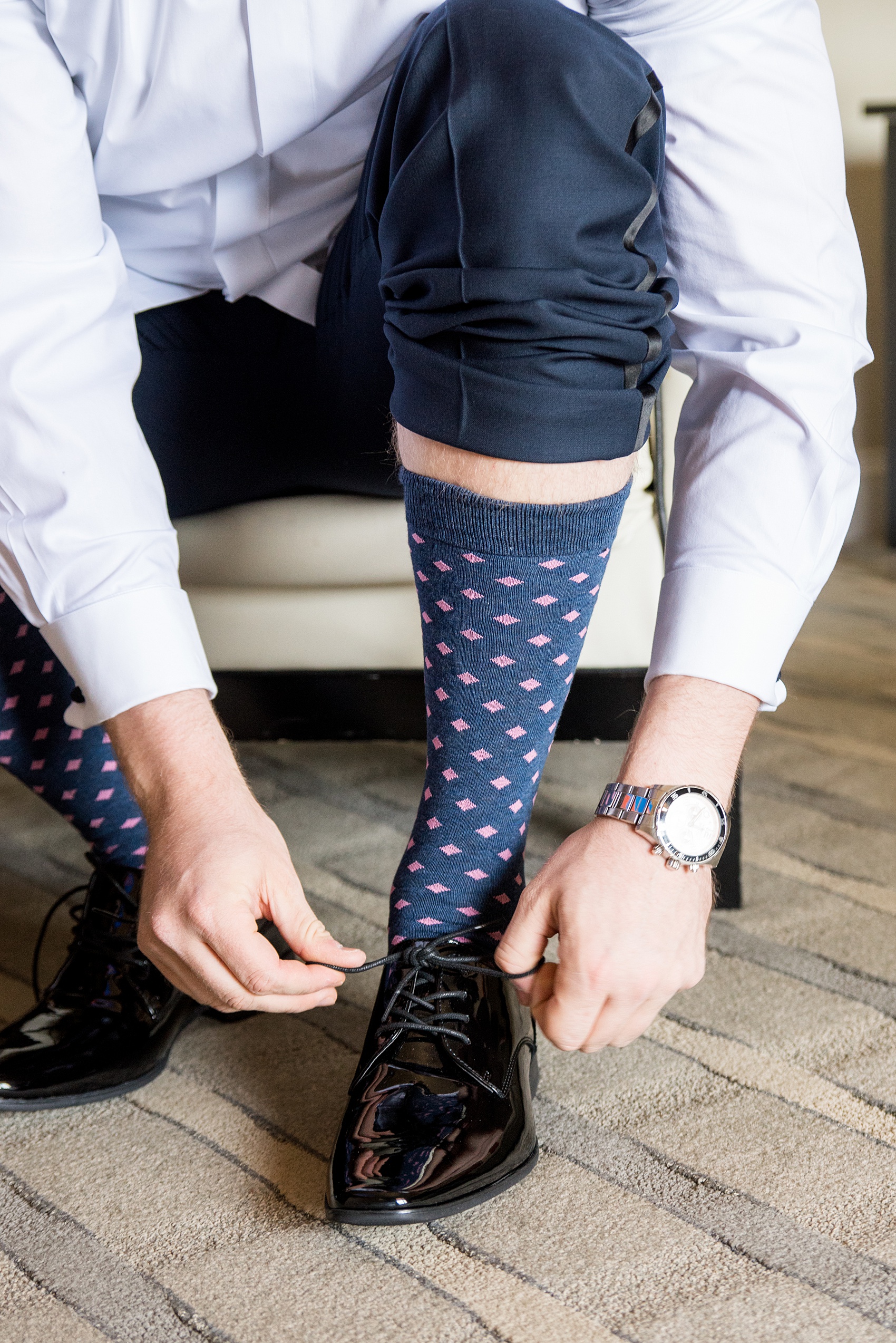 Saratoga Springs destination wedding photos by Mikkel Paige Photography. The groom prepared for his day with details like navy and pink socks, and a blush bow tie at the Pavilion Grand hotel downtown. #SaratogaSpringsNY #SaratogaSprings #mikkelpaige #NYwedding #destinationwedding 