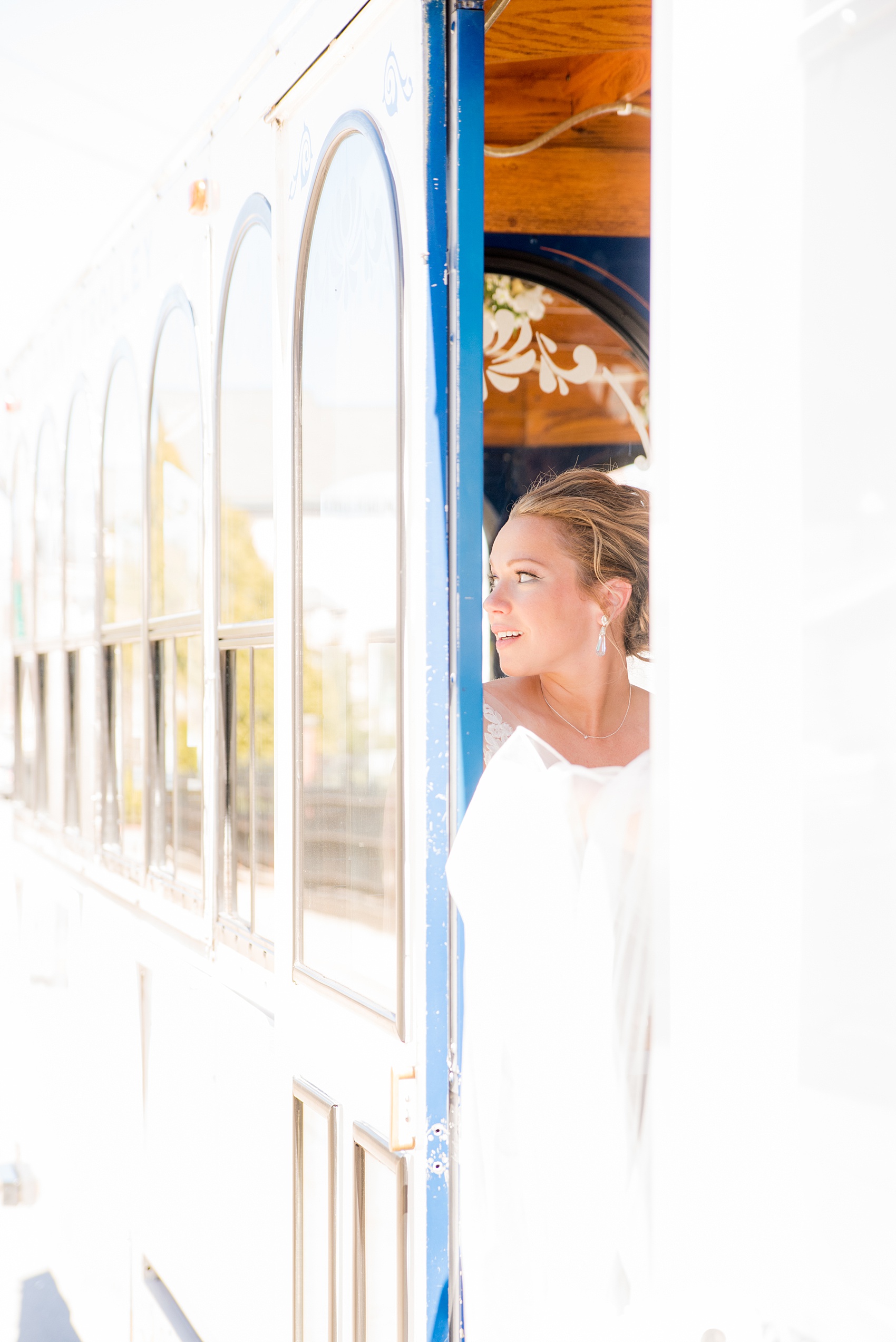 Saratoga Springs destination wedding photos by Mikkel Paige Photography. The bride waiting outside the church in a white trolley, looking to the venue for her April spring wedding. #SaratogaSpringsNY #SaratogaSprings #mikkelpaige #NYwedding #destinationwedding #KendraScottearrings