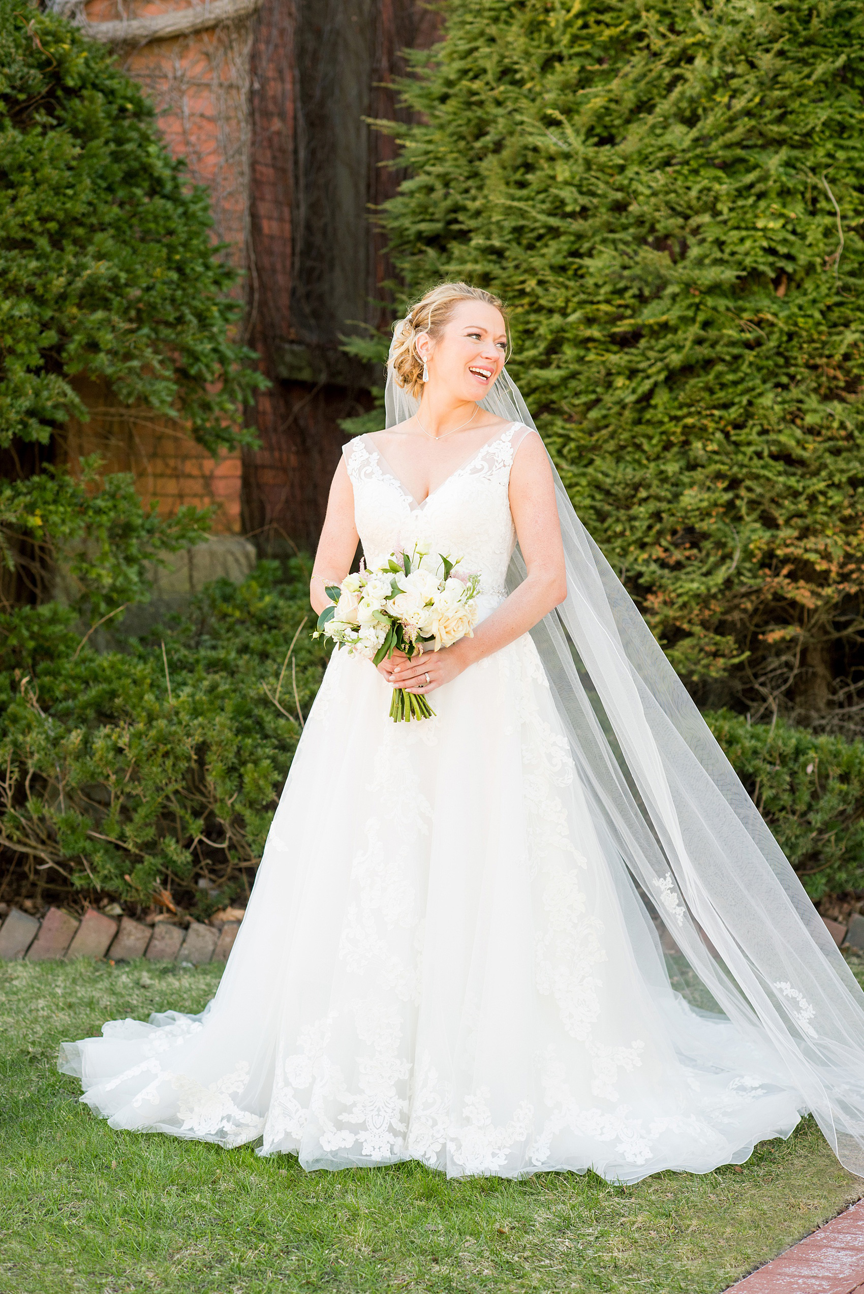 Saratoga Springs destination wedding photos by Mikkel Paige Photography. The bride wore a v-neck lace gown with tulle skirt for her reception held at Saratoga National Golf Club and church wedding ceremony. Her "something borrowed" was her long lace veil, from her sister's wedding (and Matron of Honor). #SaratogaSpringsNY #SaratogaSprings #mikkelpaige #NYwedding #destinationwedding 