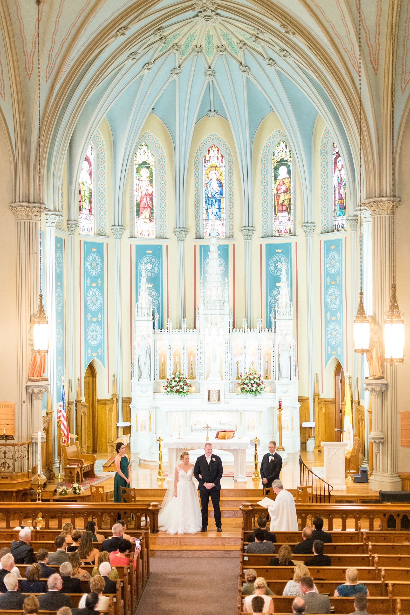 Saratoga Springs destination wedding photos by Mikkel Paige Photography. This picture shows the bride and groom getting married at St. Mary's Church in Ballston Spa, NY just fifteen minutes from the heart of downtown Saratoga. #SaratogaSpringsNY #SaratogaSprings #mikkelpaige #NYwedding #destinationwedding #ChurchWedding