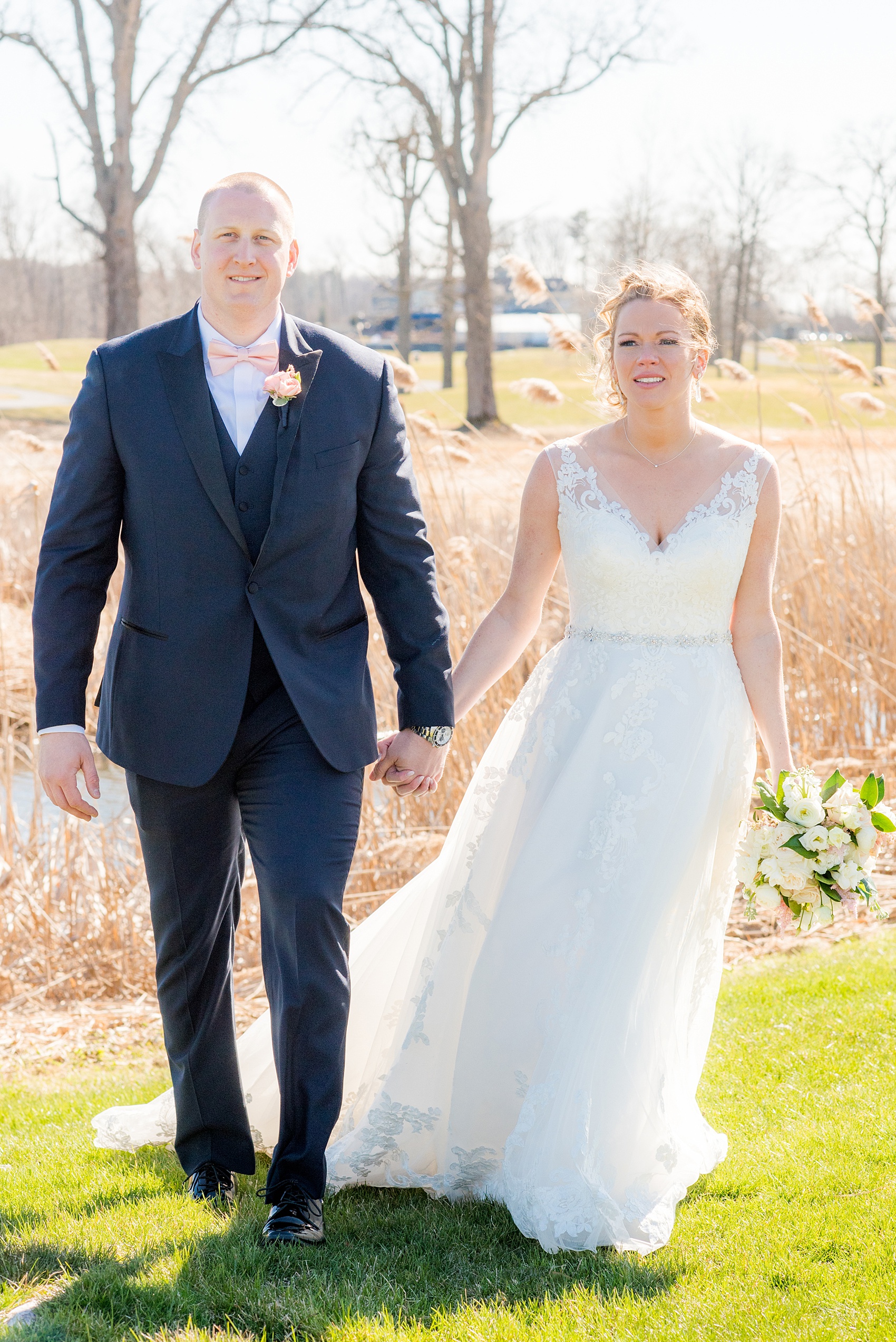 Saratoga Springs destination wedding photos by Mikkel Paige Photography. The bride and groom share a moment on the venue's green lawn surrounded by spring greenery for their reception held at Saratoga National Golf Club. #SaratogaSpringsNY #SaratogaSprings #mikkelpaige #NYwedding #destinationwedding 