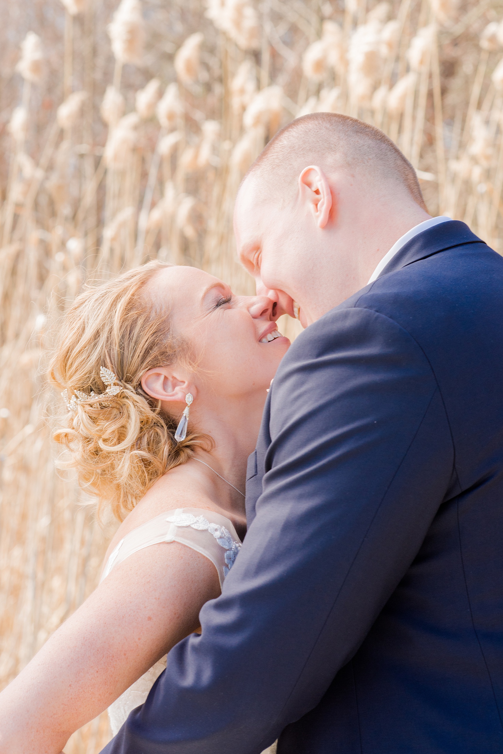 Saratoga Springs destination wedding photos by Mikkel Paige Photography. The bride and groom share a moment on the venue's property at Saratoga National Golf Club among the tall grasses for their spring, April wedding. #SaratogaSpringsNY #SaratogaSprings #mikkelpaige #NYwedding #destinationwedding 