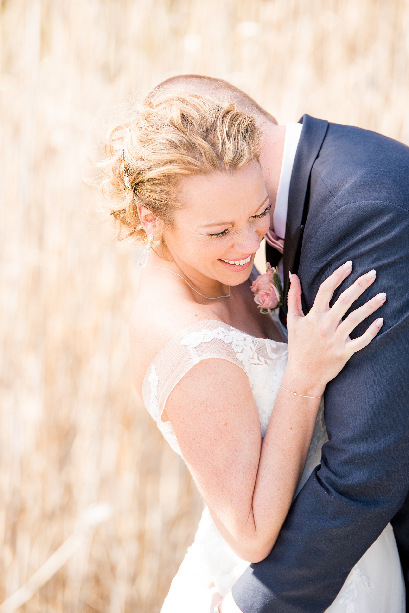 Saratoga Springs destination wedding photos by Mikkel Paige Photography. The bride and groom share a moment on the venue's property at Saratoga National Golf Club among the tall grasses for their spring, April wedding. #SaratogaSpringsNY #SaratogaSprings #mikkelpaige #NYwedding #destinationwedding 