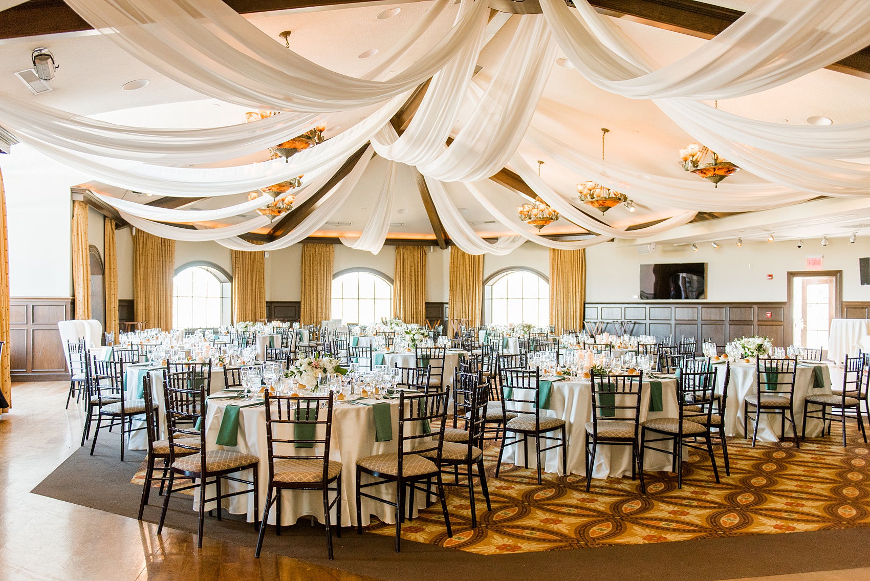 Saratoga Springs destination wedding photos by Mikkel Paige Photography. The spring event was held at Saratoga National Golf Club venue for a spring celebration. The reception room was decorated with custom white draping, and green and gold color palette elements. #SaratogaSpringsNY #SaratogaSprings #mikkelpaige #NYwedding #destinationwedding #saratogaweddingvenue #golfcoursewedding #customdraping #springwedding