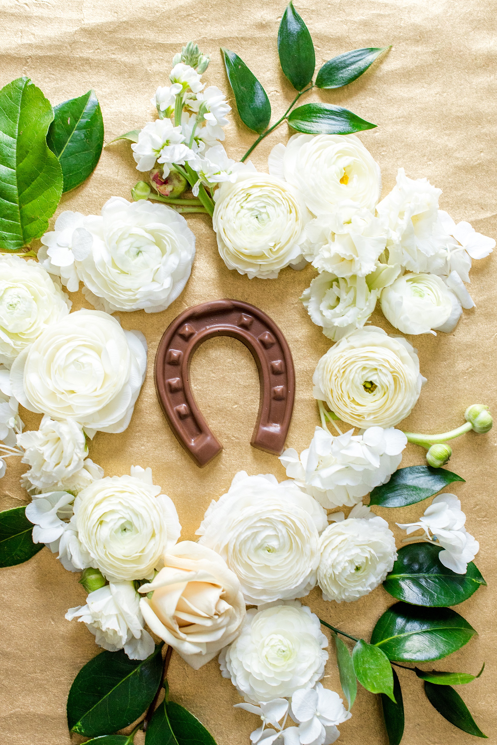 Saratoga Springs destination wedding photos by Mikkel Paige Photography. The spring event was held at Saratoga National Golf Club venue. The guest favor was chocolate horse shoes for a celebration in an area where horse-racing is a popular attraction. #SaratogaSpringsNY #SaratogaSprings #mikkelpaige #NYwedding #destinationwedding #saratogaweddingvenue #golfcoursewedding #horseracingdetails #horseshoe #chocolatefavors #weddingguestfavor #springwedding