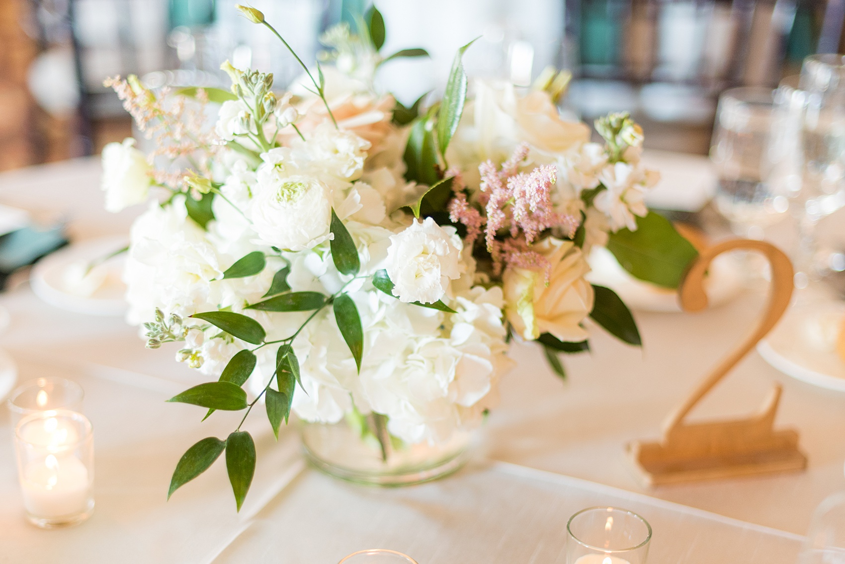 Saratoga Springs destination wedding photos by Mikkel Paige Photography. The spring event was held at Saratoga National Golf Club venue. The reception room was decorated with draping, and green and gold color palette elements including candlelight and beautiful floral centerpieces. #SaratogaSpringsNY #SaratogaSprings #mikkelpaige #NYwedding #destinationwedding #saratogaweddingvenue #golfcoursewedding #greenandgold #greenandgoldwedding #springwedding