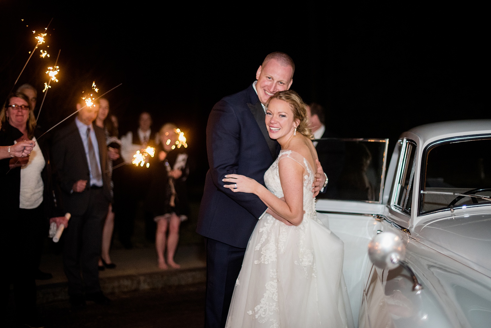 Saratoga Springs destination wedding photos by Mikkel Paige Photography. The party was held at Saratoga National Golf Club venue. The bride and groom did a sparkler exit from their spring reception and left in a vintage Rolls Royce car. #SaratogaSpringsNY #SaratogaSprings #mikkelpaige #NYwedding #destinationwedding #sparklerexit