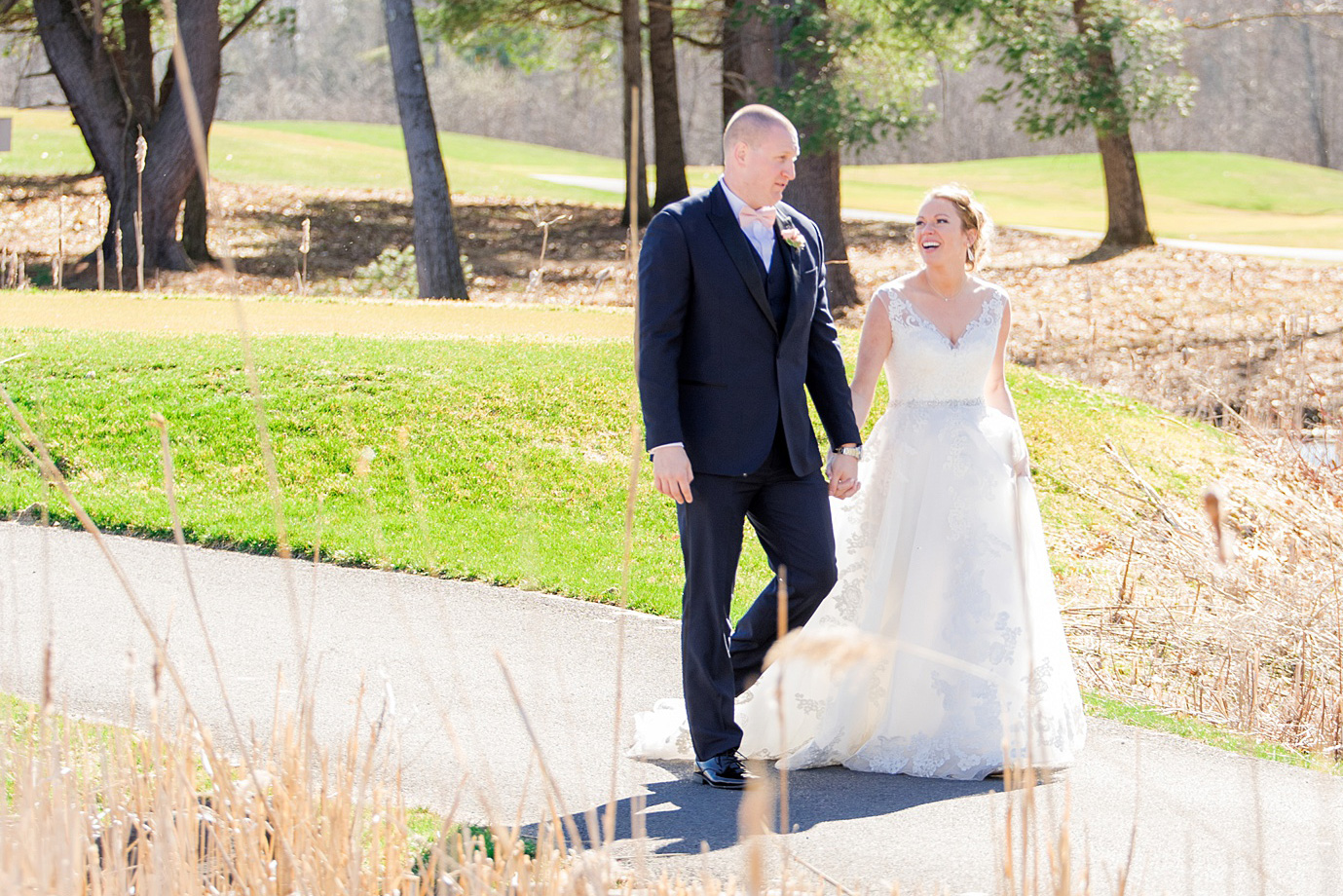 Photos from Saratoga Springs, New York by Mikkel Paige Photography. This picture shows the bride and groom walking on the golf course during their spring wedding. #SaratogaSprings #golfcoursewedding #SaratogaSpringsNY #SpringWedding