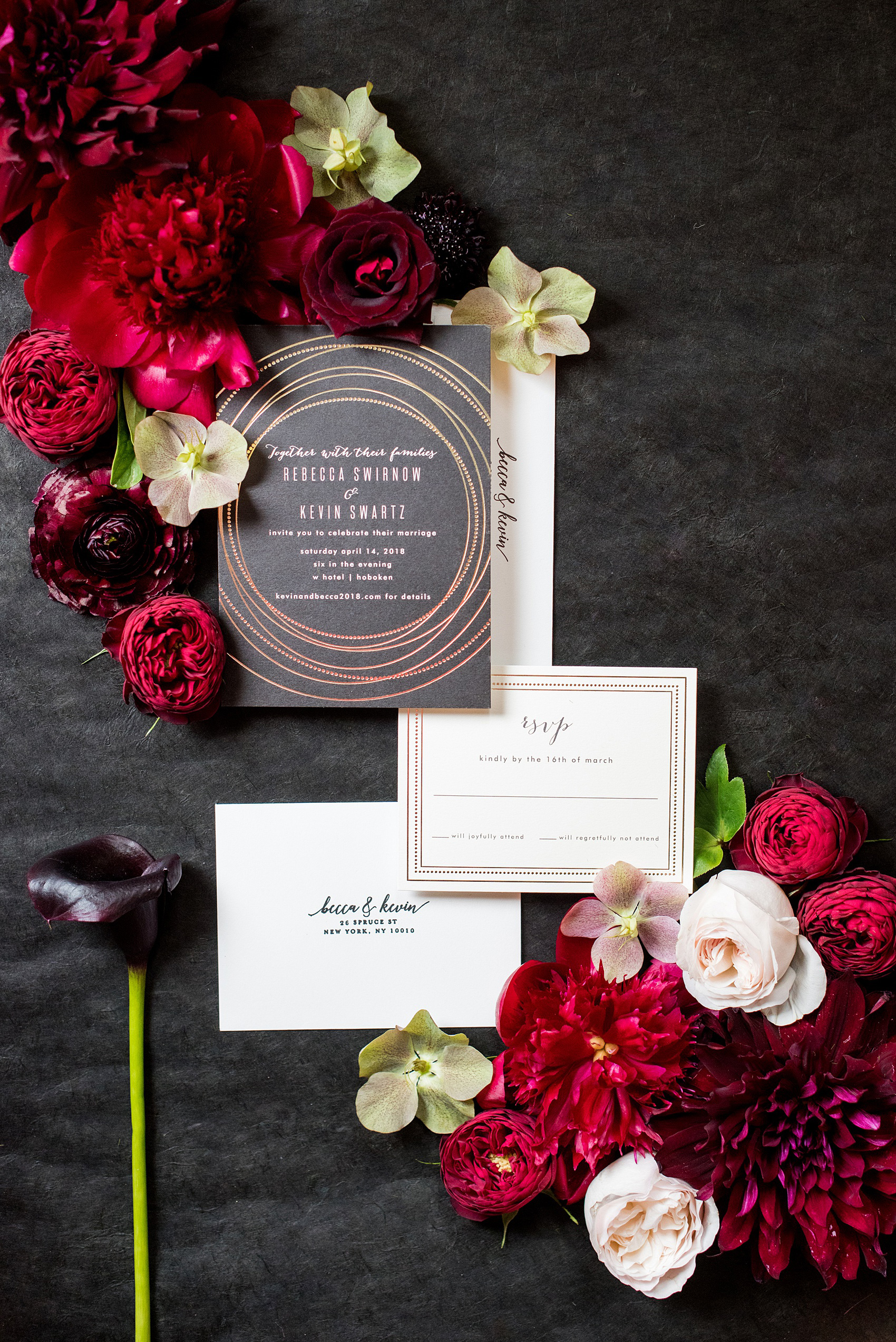 W Hoboken wedding photos by Mikkel Paige Photography at this NJ venue. Pictures in this well known New Jersey city with a view of the NYC skyline. This detail image includes a black and gold invitation from Minted, and flowers from Sachi Rose designed in a lay flat suite by the photographer. Red, fuchsia and burgundy peonies, calla lilies, Japanese roses, helebores dahlias and ranunculus complete the scene. #mikkelpaige #HobokenWedding #NewJerseyPhotographer #NewYorkCityPhotographer #NYCweddingphotographer #brideandgroomphotos #redpeonies #romanticwedding #springwedding #CityWedding