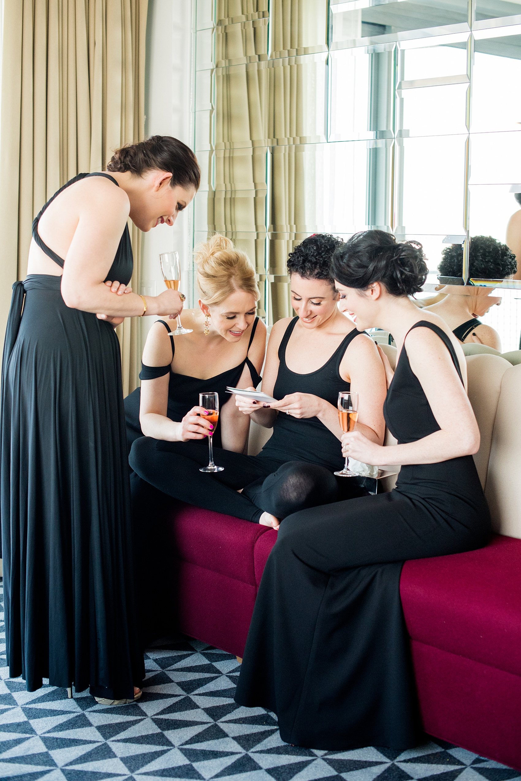 W Hoboken wedding photos by Mikkel Paige Photography at this NJ venue. Pictures in this well known New Jersey city with a view of the NYC skyline. Image of the bridesmaids reading a card from the groom to the bride during getting ready. #mikkelpaige #HobokenWedding #NewJerseyPhotographer #NewYorkCityPhotographer #NYCweddingphotographer #brideandgroomphotos #redpeonies #romanticwedding #springwedding #CityWedding