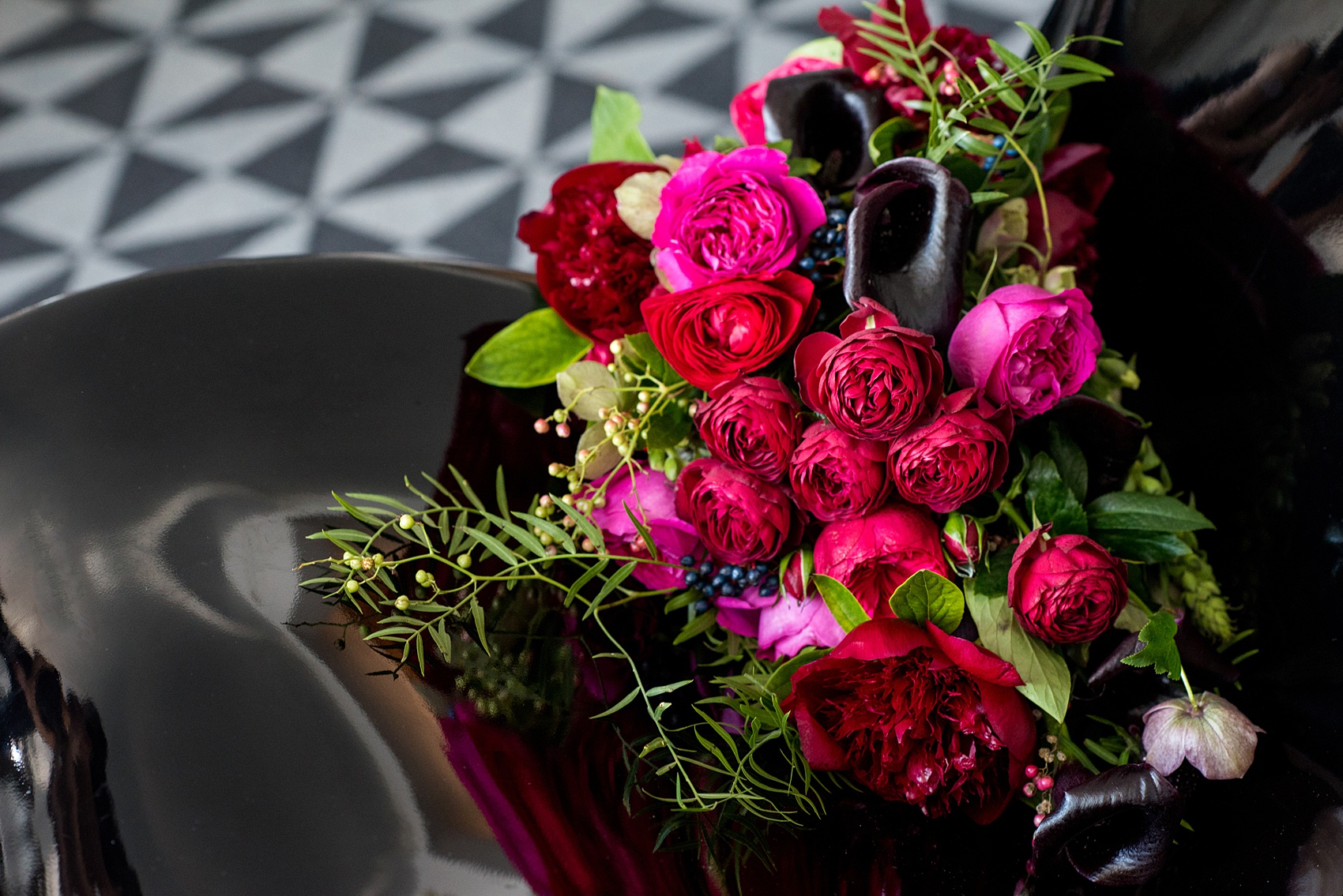 W Hoboken wedding photos by Mikkel Paige Photography at this NJ venue. Pictures in this well known New Jersey city with a view of the NYC skyline. This detail image is of the semi-cascading bouquet includes red, fuchsia and burgundy peonies, calla lilies, Japanese roses, helebores dahlias and ranunculus by Sachi Rose Design. #mikkelpaige #HobokenWedding #NewJerseyPhotographer #NewYorkCityPhotographer #NYCweddingphotographer #brideandgroomphotos #redpeonies #romanticwedding #springwedding #CityWedding