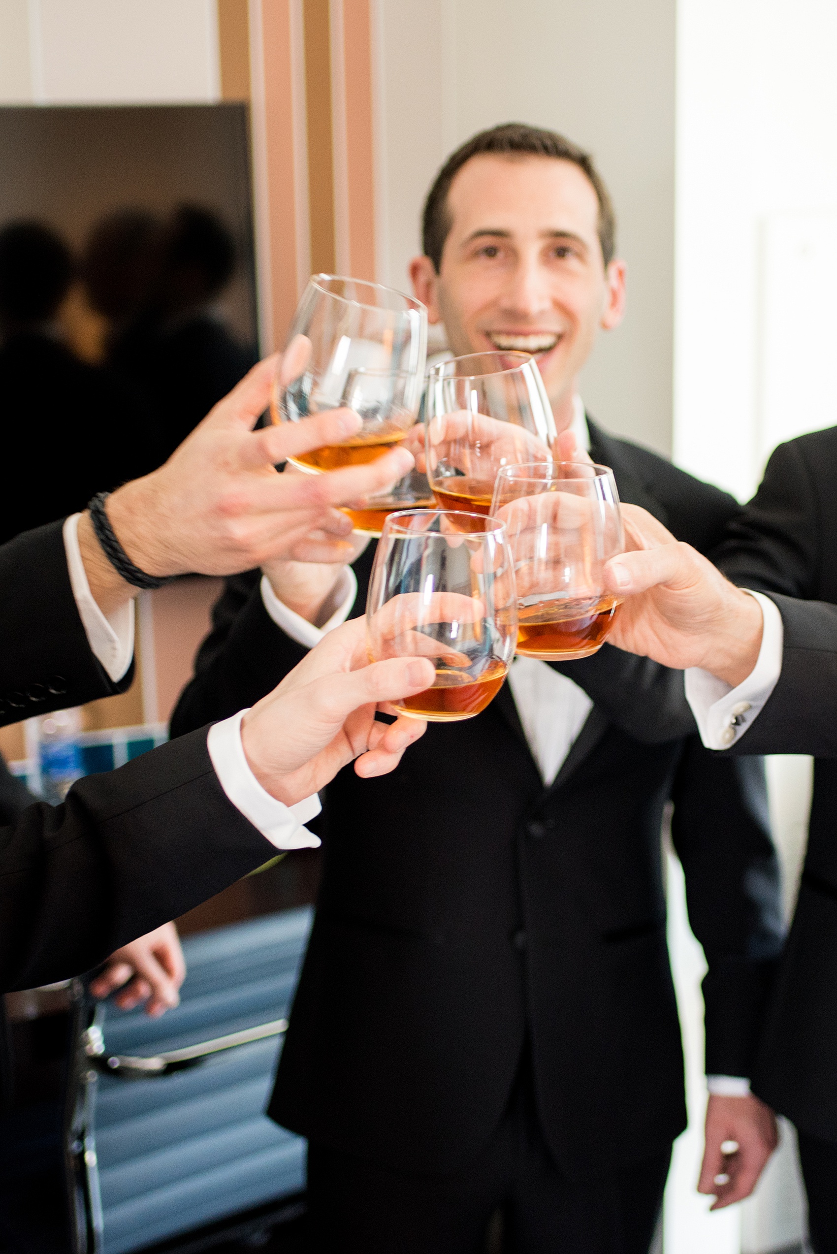 W Hoboken wedding photos by Mikkel Paige Photography. Pictures in this well known New Jersey venue with a view of the Manhattan skyline. Image of the groom and his groomsmen during the start of the afternoon, getting ready at the colorful teal Starwood hotel drinking whiskey. #mikkelpaige #HobokenWedding #NewJerseyPhotographer #NewYorkCityPhotographer #NYCweddingphotographer #brideandgroomphotos #redpeonies #romanticwedding #springwedding #CityWedding