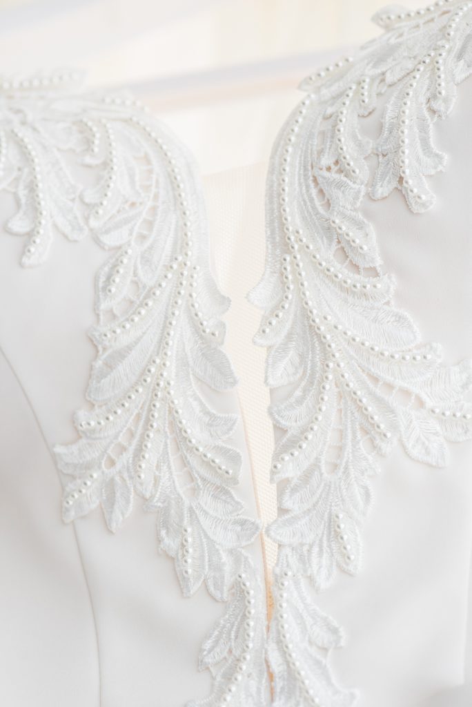 W Hoboken wedding photos by Mikkel Paige Photography. Detail picture of the beading on the bride's off-white, strapless Paloma Blanca gown inside the venue hotel room during getting ready. #mikkelpaige #HobokenWedding #NewJerseyPhotographer #NewYorkCityPhotographer #NYCweddingphotographer #brideandgroomphotos #redpeonies #romanticwedding #springwedding #CityWedding