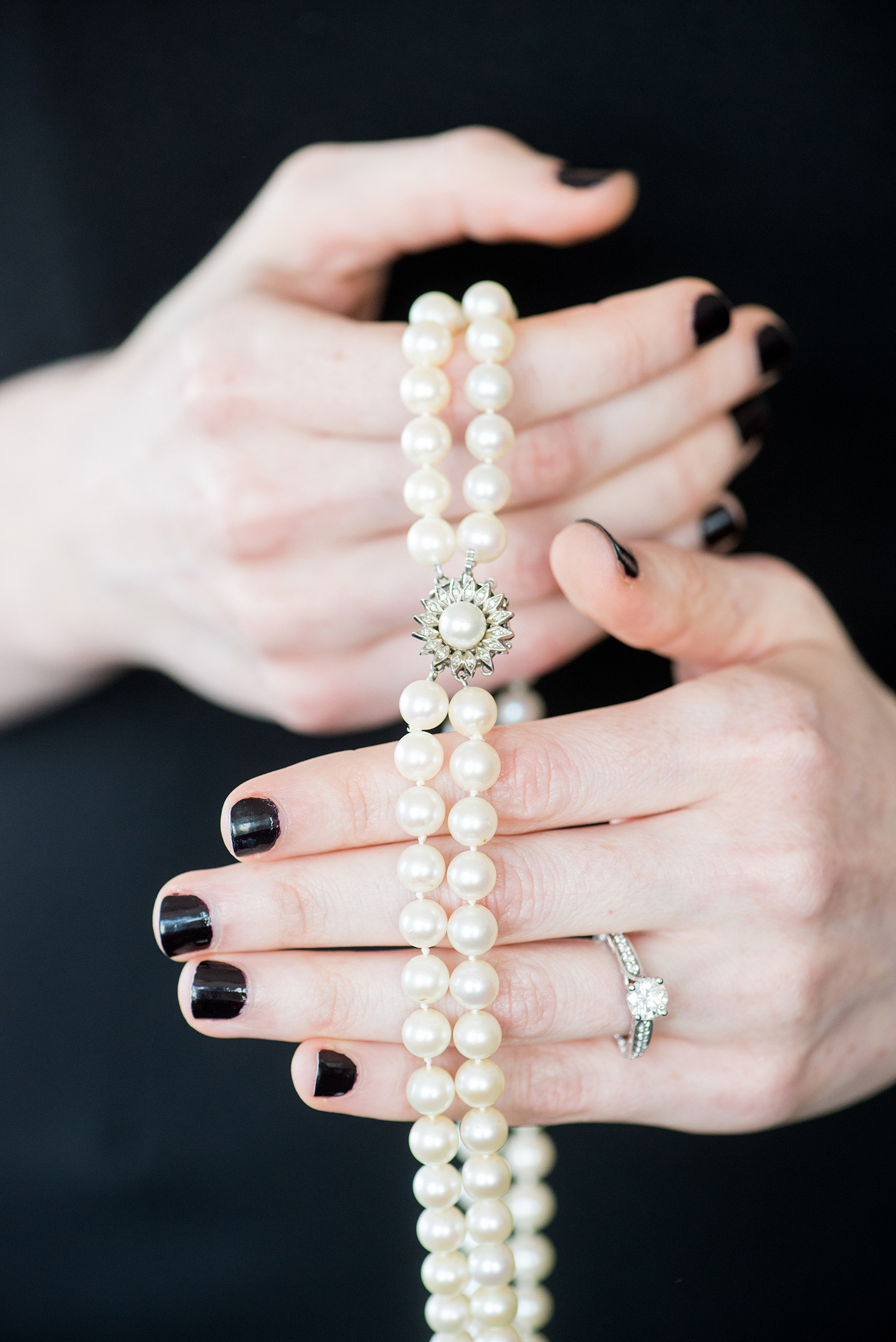 W Hoboken wedding photos by Mikkel Paige Photography. Detail picture of the bride's grandmother's heirloom pearls that her sister wore so they'd be close by (and borrowed) on her day. #mikkelpaige #HobokenWedding #NewJerseyPhotographer #NewYorkCityPhotographer #NYCweddingphotographer #brideandgroomphotos #redpeonies #romanticwedding #springwedding #CityWedding