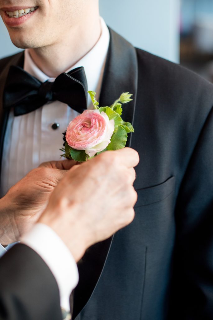 W Hoboken wedding photos by Mikkel Paige Photography. Picture of the varied boutonnieres for the groom and groomsmen by Sachi Rose Designs, including ranunculus, geranium leaves and cosmos. #mikkelpaige #HobokenWedding #NewJerseyPhotographer #NewYorkCityPhotographer #NYCweddingphotographer #brideandgroomphotos #redpeonies #romanticwedding #springwedding #CityWedding