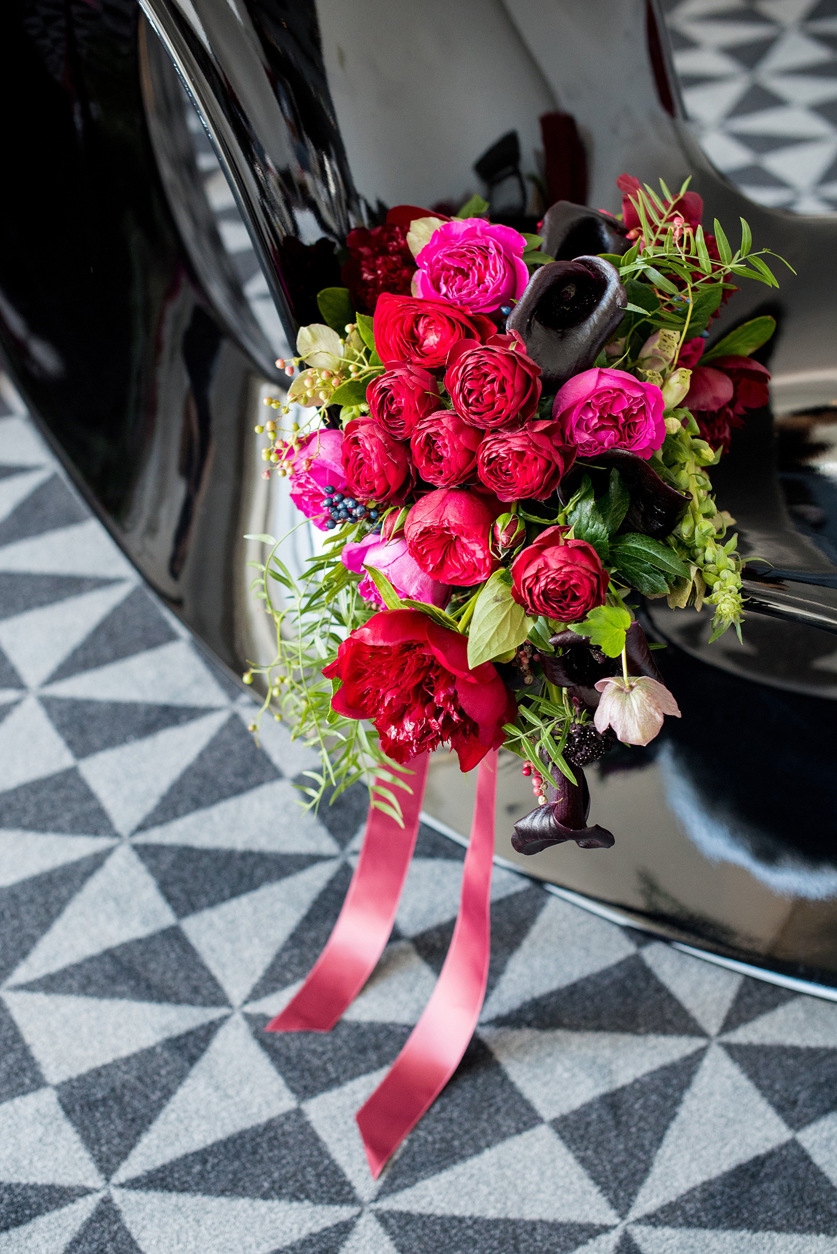 W Hoboken wedding photos by Mikkel Paige Photography at this NJ venue. Pictures in this well known New Jersey city with a view of the NYC skyline. This detail image is of the semi-cascading bouquet includes red, fuchsia and burgundy peonies, calla lilies, Japanese roses, helebores dahlias and ranunculus by Sachi Rose Design. #mikkelpaige #HobokenWedding #NewJerseyPhotographer #NewYorkCityPhotographer #NYCweddingphotographer #brideandgroomphotos #redpeonies #romanticwedding #springwedding #CityWedding