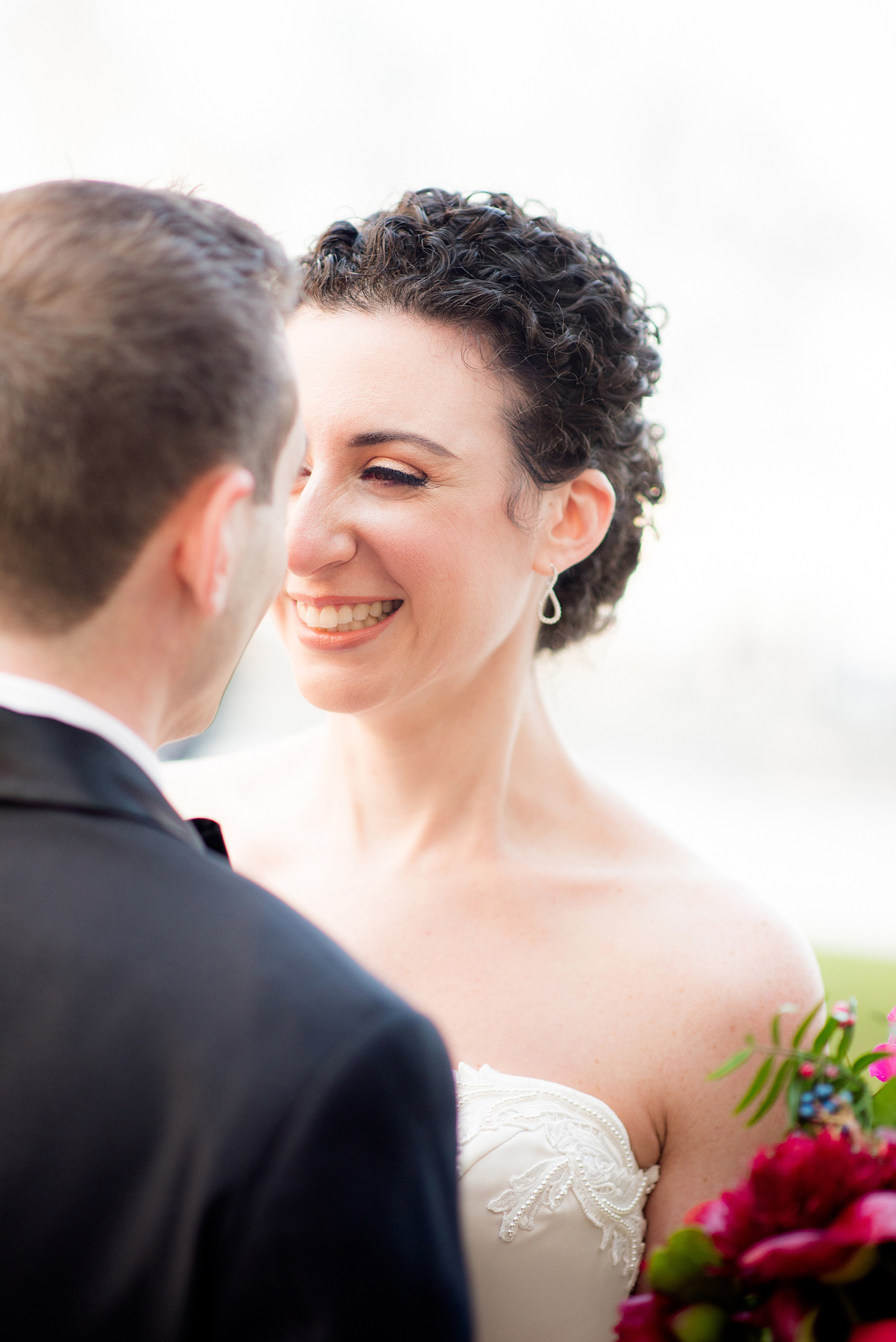 W Hoboken wedding photos by Mikkel Paige Photography. Pictures in this well known New Jersey area with a view of the Manhattan skyline. The bride smiled at her groom after their first look outside of the venue. #mikkelpaige #HobokenWedding #NewJerseyPhotographer #NewYorkCityPhotographer #NYCweddingphotographer #brideandgroomphotos #redpeonies #romanticwedding #springwedding #CityWedding