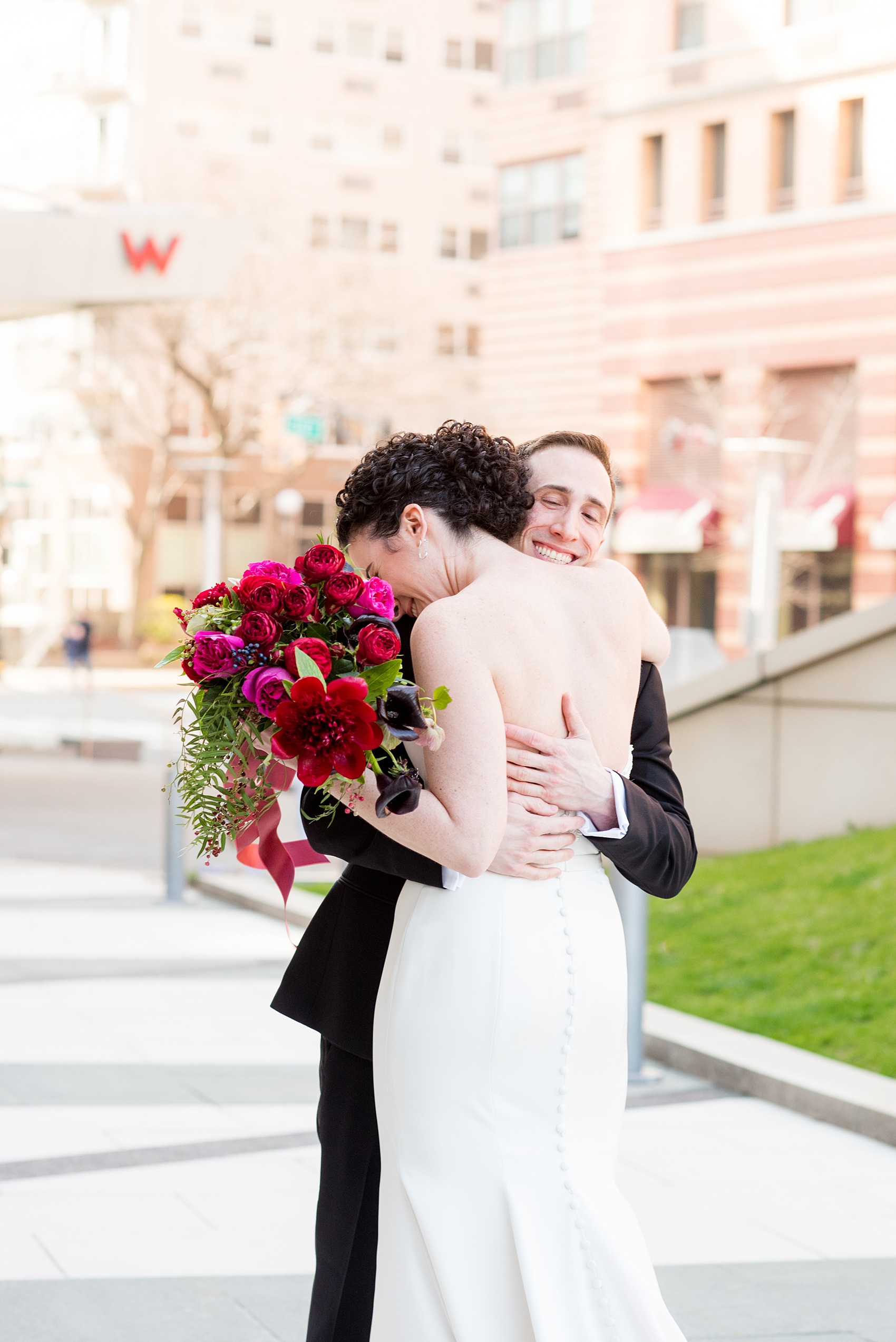 W Hoboken wedding photos by Mikkel Paige Photography at this NJ venue. Pictures in this well known New Jersey city with a view of the NYC skyline. The bride and the groom wore romantic colors including burgundy, fuchsia, red and classic black. Flowers by Sachi Rose Design. #mikkelpaige #HobokenWedding #NewJerseyPhotographer #NewYorkCityPhotographer #NYCweddingphotographer #brideandgroomphotos #redpeonies #romanticwedding #springwedding #CityWedding