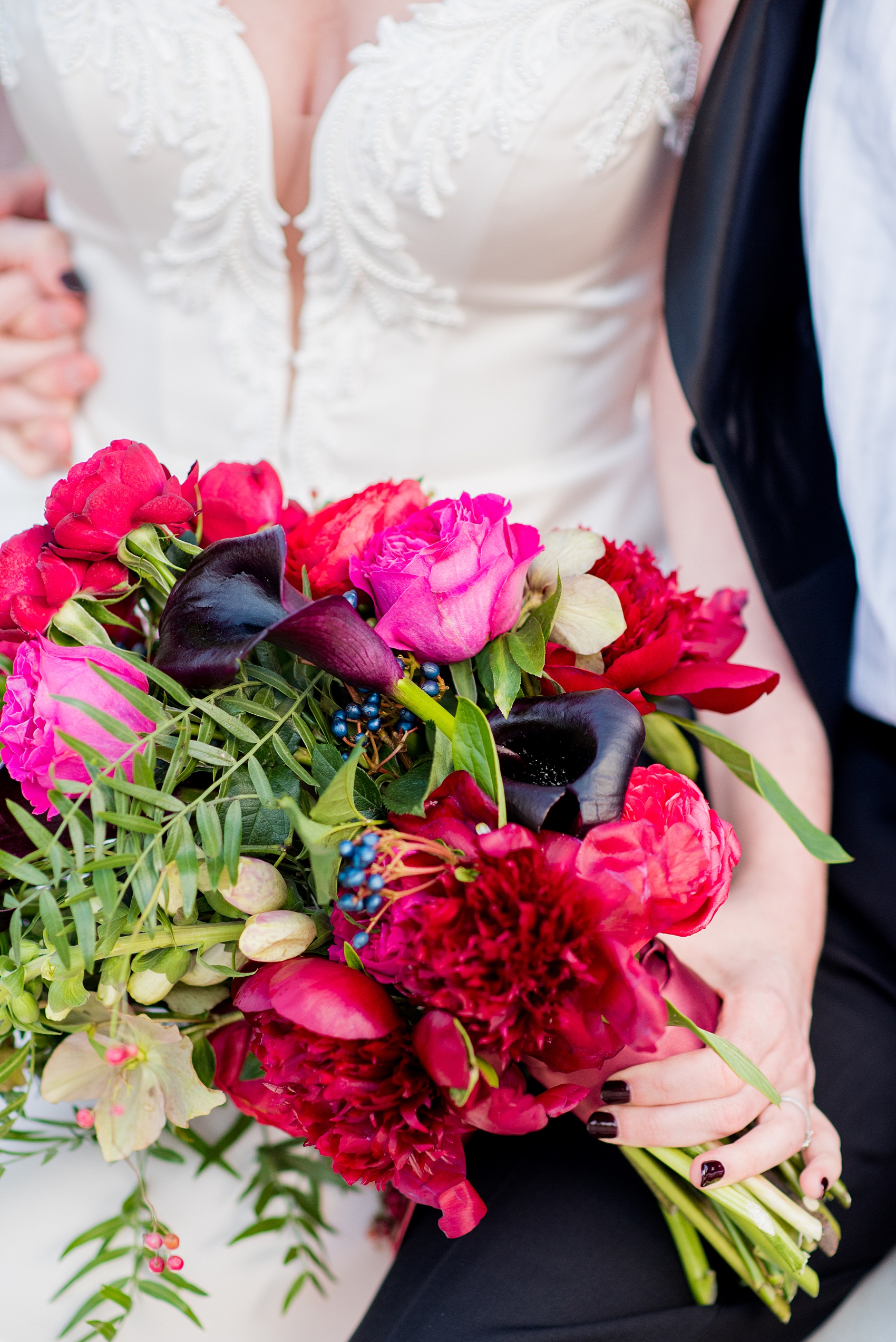 W Hoboken wedding photos by Mikkel Paige Photography. Picture of the bride's unique, semi strapless bouquet by Sachi Rose Designs. It included beautiful red, burgundy, fuchsia and pink peonies and calla lilies, as well as ranunculus and Japanese roses. #mikkelpaige #HobokenWedding #NewJerseyPhotographer #NewYorkCityPhotographer #NYCweddingphotographer #brideandgroomphotos #redpeonies #romanticwedding #springwedding #CityWedding