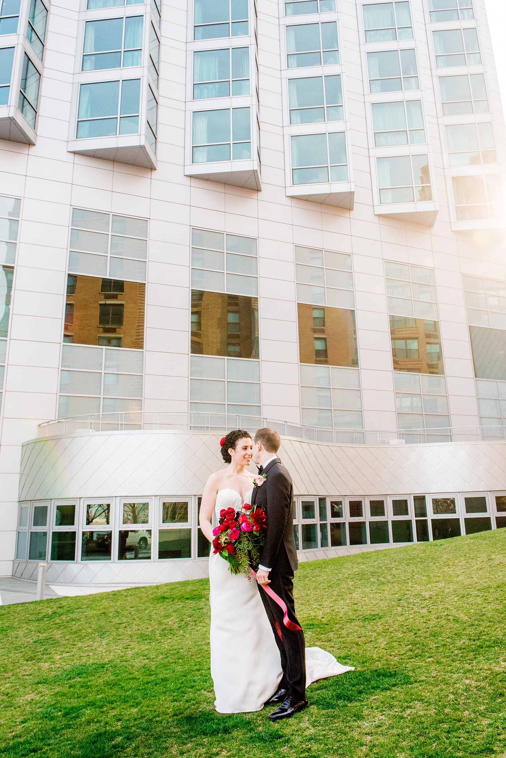 W Hoboken wedding photos at this New Jersey hotel overlooking the Manhattan skyline. Photos by Mikkel Paige Photography of the bride and groom in romantic, sexy yet classic and elegant outfits. The bride wore a strapless, pearl beaded form-fitting gown and the groom wore a classic black tuxedo. #mikkelpaige #HobokenWedding #NewJerseyPhotographer #NewYorkCityPhotographer #NYCweddingphotographer #brideandgroomphotos #redpeonies #romanticwedding #springwedding #CityWedding