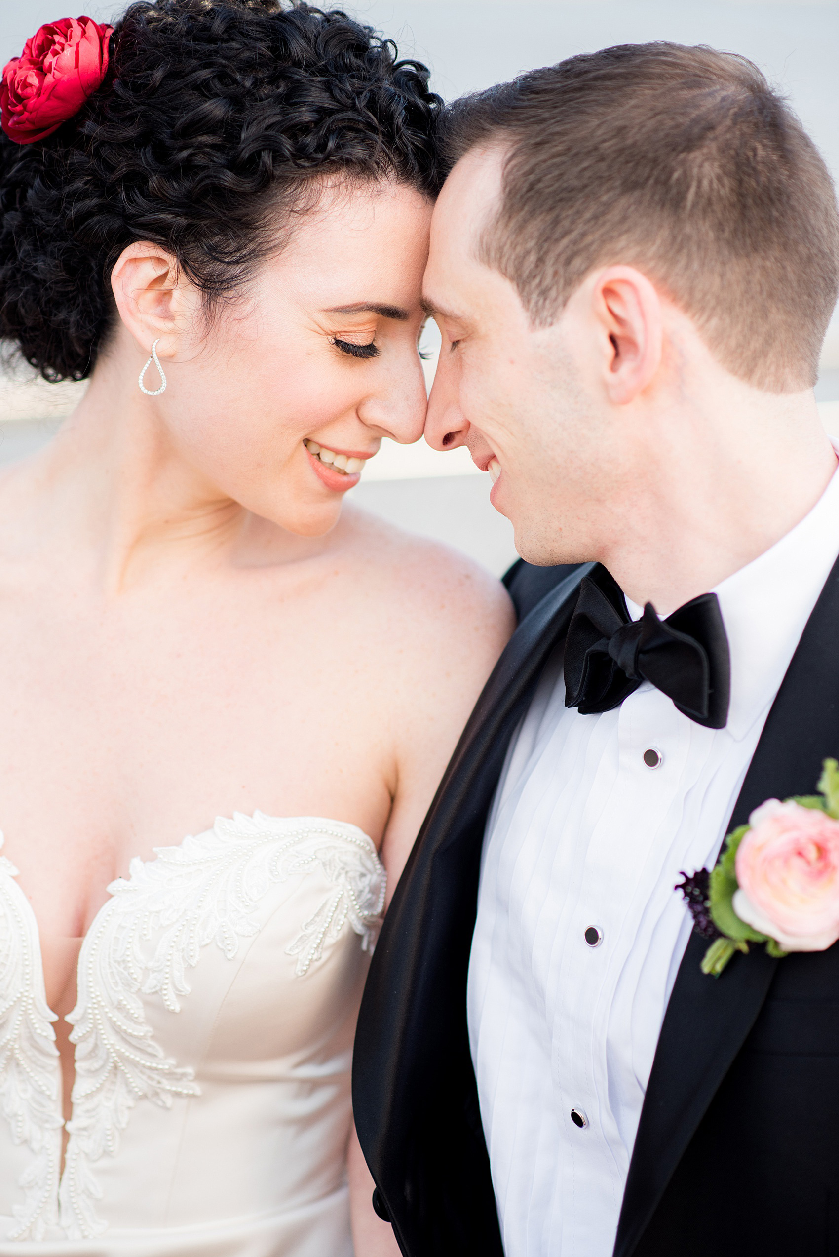 W Hoboken wedding photos at this New Jersey hotel overlooking the Manhattan skyline. Photos by Mikkel Paige Photography of the bride and groom in romantic, sexy yet classic and elegant outfits. The bride wore a strapless, pearl beaded form-fitting gown and the groom wore a classic black tuxedo. #mikkelpaige #HobokenWedding #NewJerseyPhotographer #NewYorkCityPhotographer #NYCweddingphotographer #brideandgroomphotos #redpeonies #romanticwedding #springwedding #CityWedding