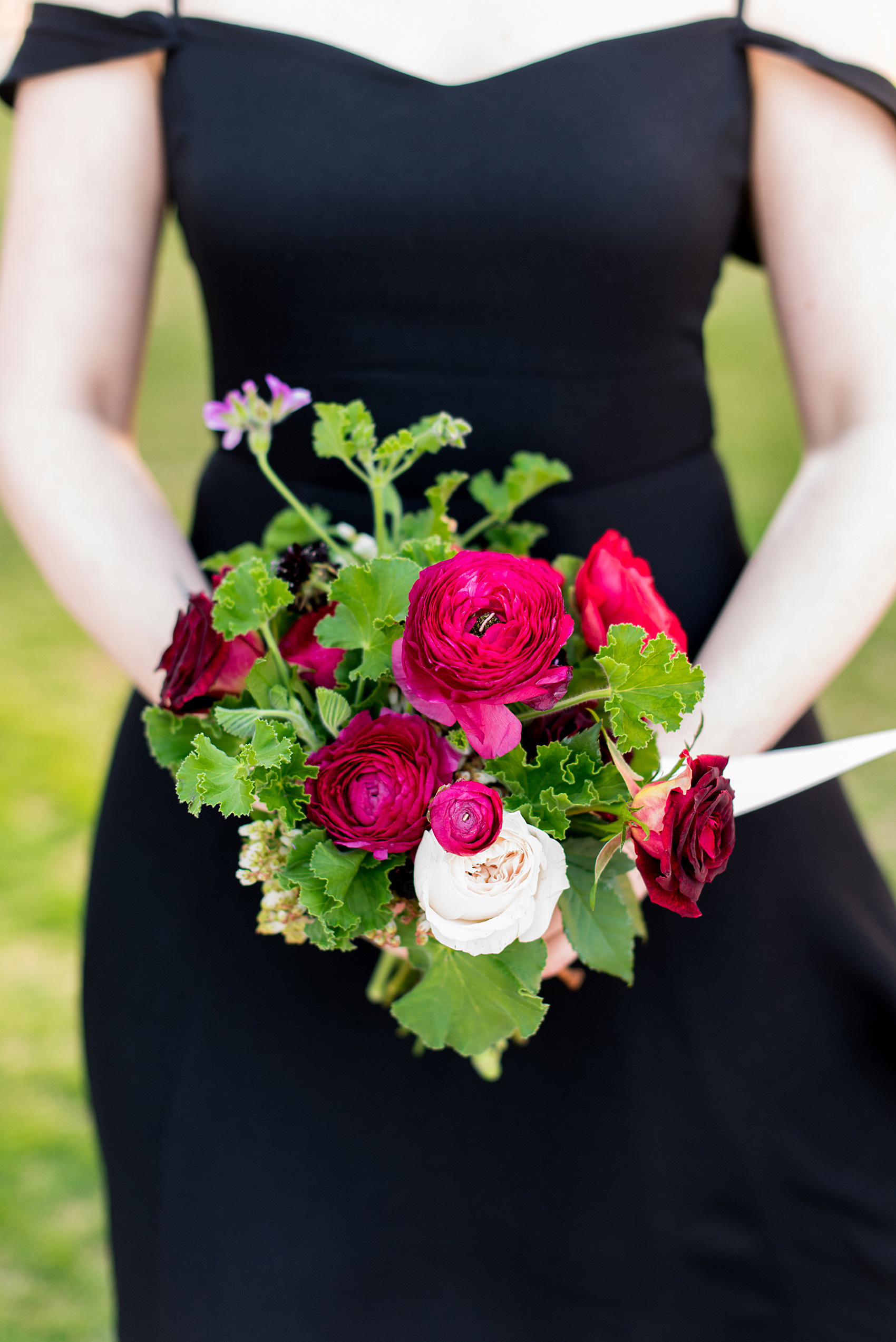 W Hoboken wedding photos by Mikkel Paige Photography. Picture of the bridesmaid's unique, small bouquet by Sachi Rose Designs. It included beautiful red, burgundy, flowers (like peonies and calla lilies, as well as ranunculus and Japanese roses and andromeda) and green Geranium leaves. It was tied with long satin ribbons. #mikkelpaige #HobokenWedding #NewJerseyPhotographer #NewYorkCityPhotographer #NYCweddingphotographer #brideandgroomphotos #redpeonies #romanticwedding #springwedding #CityWedding