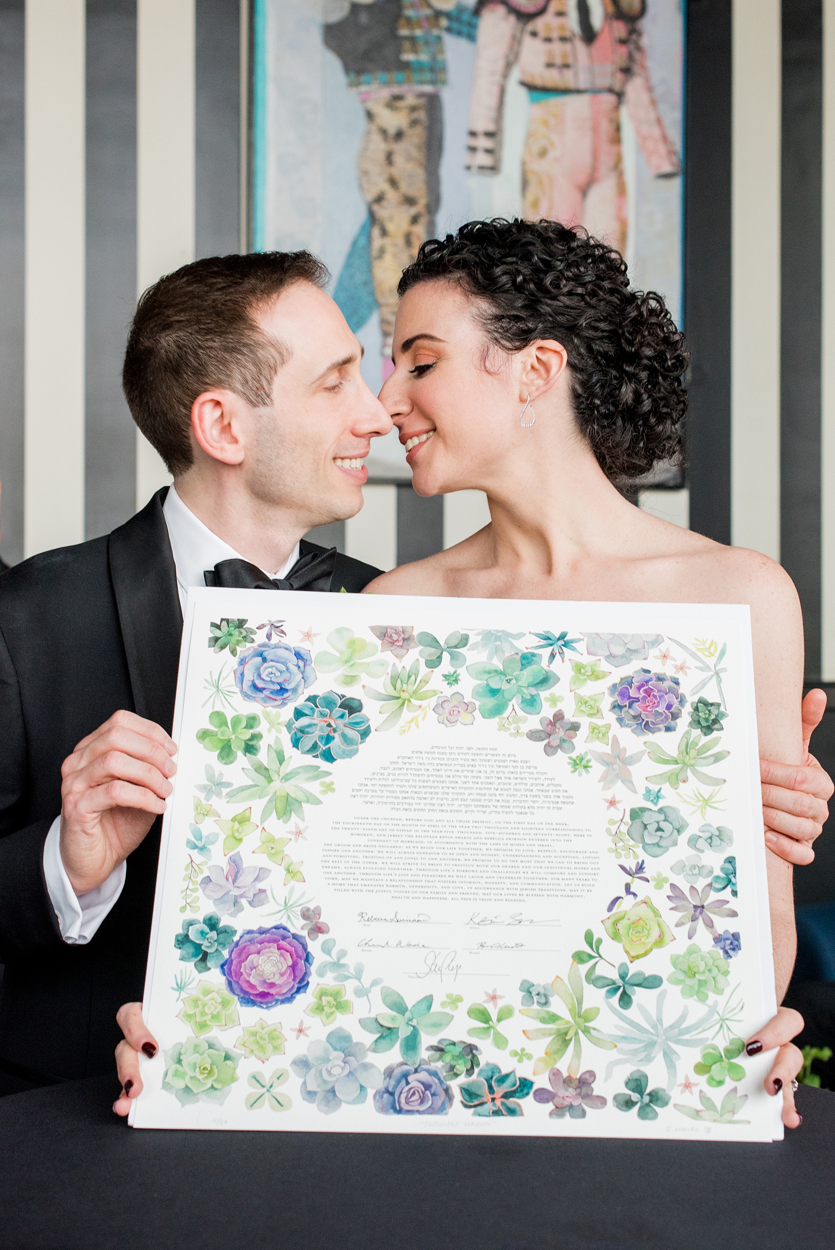 W Hoboken wedding photos at this New Jersey venue overlooking the NYC skyline by Mikkel Paige Photography. Picture of the watercolor handpainted succulent ketubbah and the bride and groom holding it after the traditional Jewish ceremony. #mikkelpaige #HobokenWedding #NewJerseyPhotographer #NewYorkCityPhotographer #NYCweddingphotographer #brideandgroomphotos #redpeonies #romanticwedding #springwedding #CityWedding #JewishWedding #Chuppah