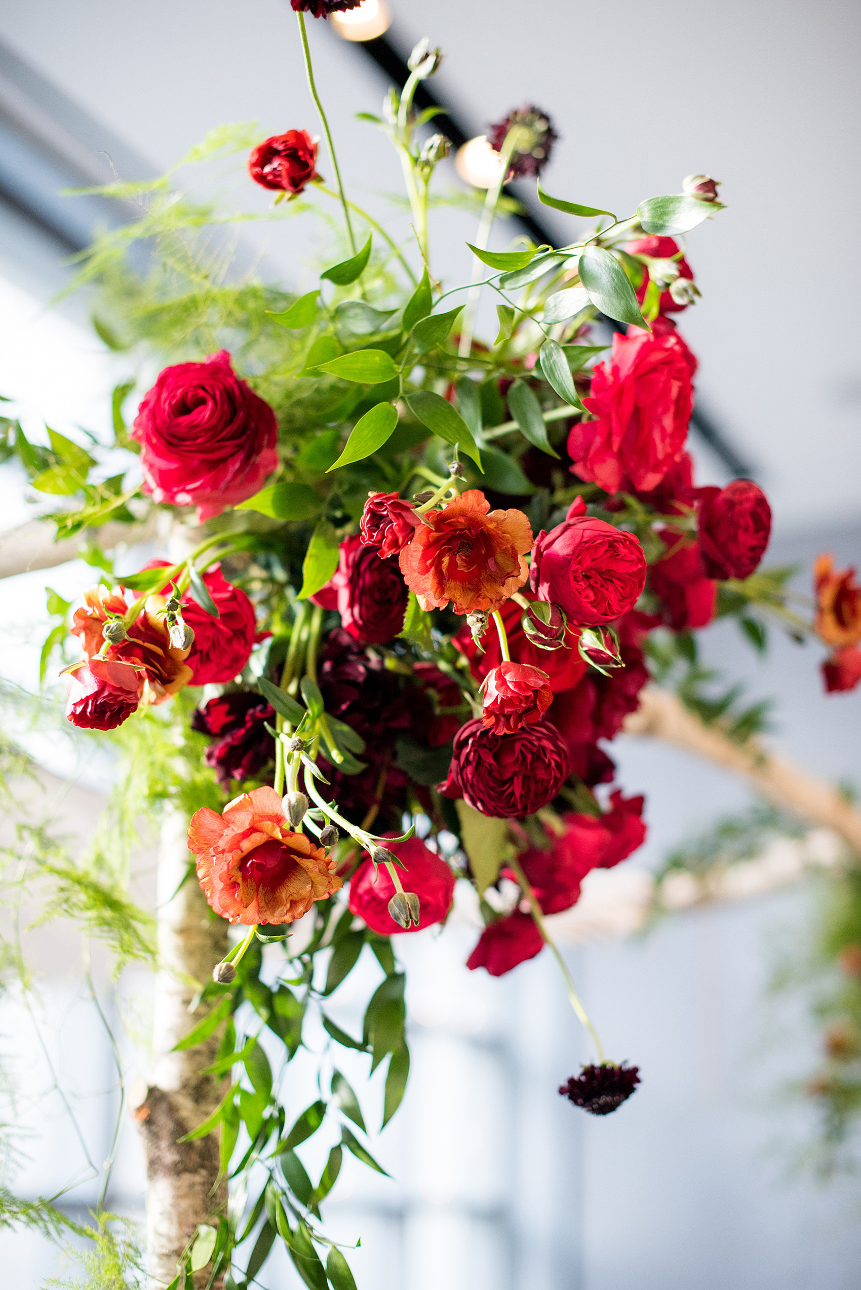 W Hoboken wedding photos at this New Jersey venue overlooking the NYC skyline. Photos by Mikkel Paige Photography of the indoor ceremony with a birch branch chuppah. Sachi Rose Design decorated it with red, pink, fuchsia and burgundy flowers. #mikkelpaige #HobokenWedding #NewJerseyPhotographer #NewYorkCityPhotographer #NYCweddingphotographer #brideandgroomphotos #redpeonies #romanticwedding #springwedding #CityWedding #JewishWedding #Chuppah