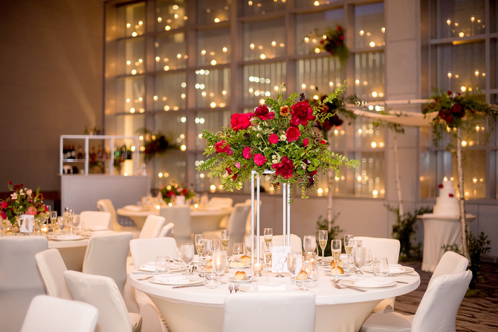 W Hoboken wedding photos at this New Jersey hotel overlooking the NYC skyline. Photos by Mikkel Paige Photography of the reception centerpiece with foxglove, burgundy calla lilies, roses, red peonies, and pink ranunculus by Sachi Rose Design. #mikkelpaige #HobokenWedding #NewJerseyPhotographer #NewYorkCityPhotographer #NYCweddingphotographer #brideandgroomphotos #redpeonies #romanticwedding #springwedding #CityWedding