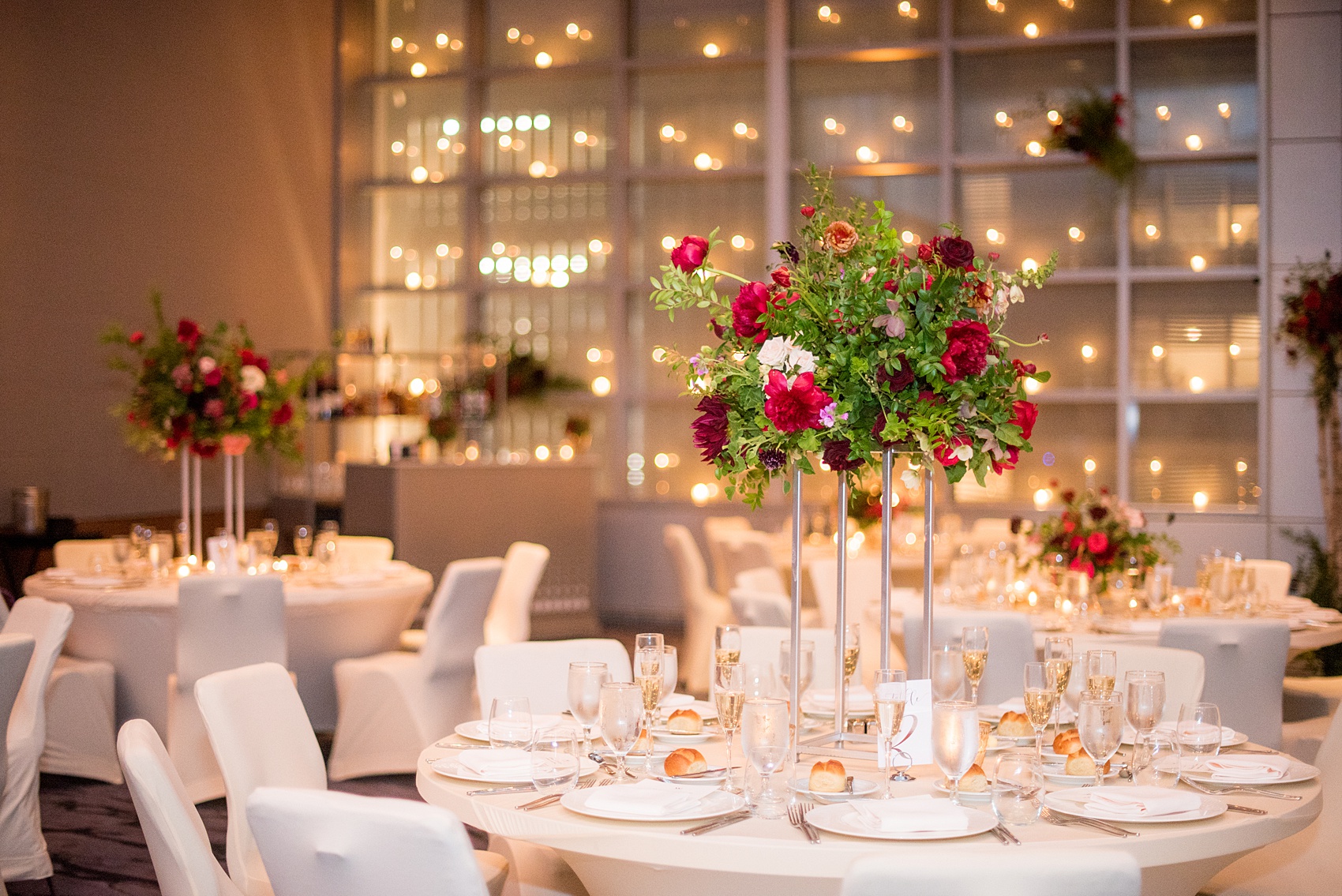 W Hoboken wedding photos at this New Jersey hotel overlooking the NYC skyline. Photos by Mikkel Paige Photography of the reception centerpiece with foxglove, burgundy calla lilies, roses, red peonies, and pink ranunculus by Sachi Rose Design. #mikkelpaige #HobokenWedding #NewJerseyPhotographer #NewYorkCityPhotographer #NYCweddingphotographer #brideandgroomphotos #redpeonies #romanticwedding #springwedding #CityWedding