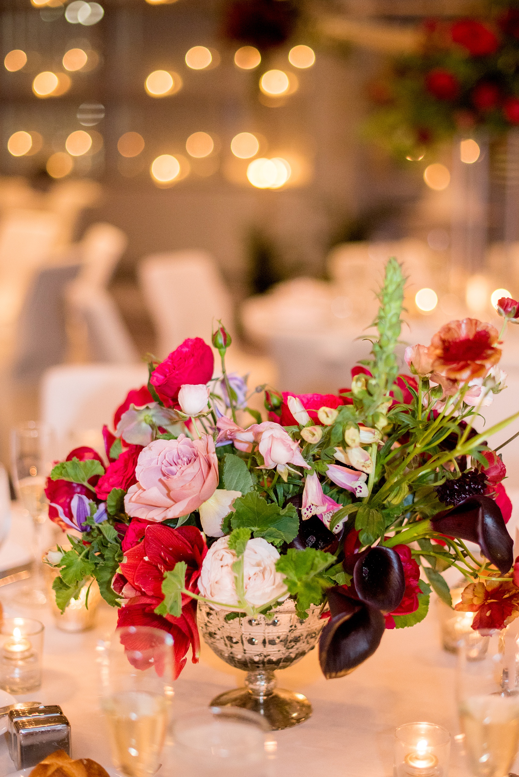 W Hoboken wedding photos at this New Jersey hotel overlooking the NYC skyline. Photos by Mikkel Paige Photography of the reception centerpiece with foxglove, burgundy calla lilies, roses, red peonies, and pink ranunculus by Sachi Rose Design. #mikkelpaige #HobokenWedding #NewJerseyPhotographer #NewYorkCityPhotographer #NYCweddingphotographer #brideandgroomphotos #redpeonies #romanticwedding #springwedding #CityWedding