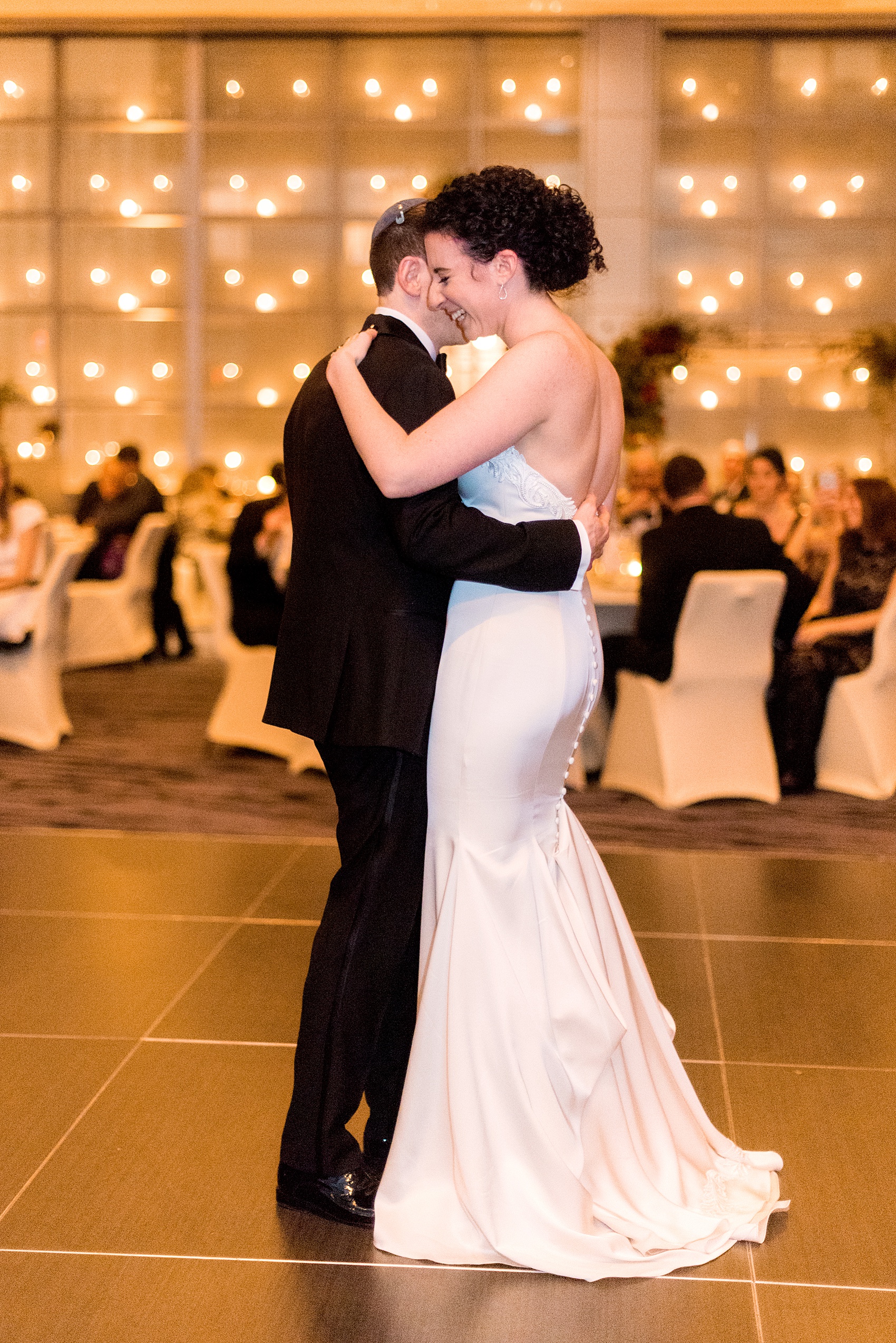 W Hoboken wedding photos at this New Jersey hotel overlooking the NYC skyline. Photos by Mikkel Paige Photography of the couples first dance and candlelight wall at the venue. #mikkelpaige #HobokenWedding #NewJerseyPhotographer #NewYorkCityPhotographer #NYCweddingphotographer #brideandgroomphotos #redpeonies #romanticwedding #springwedding #CityWedding