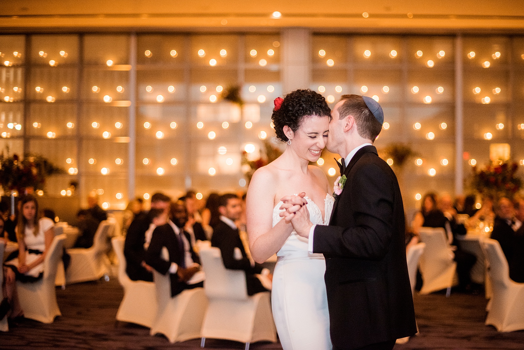 W Hoboken wedding photos at this New Jersey hotel overlooking the NYC skyline. Photos by Mikkel Paige Photography of the couples first dance and candlelight wall at the venue. #mikkelpaige #HobokenWedding #NewJerseyPhotographer #NewYorkCityPhotographer #NYCweddingphotographer #brideandgroomphotos #redpeonies #romanticwedding #springwedding #CityWedding