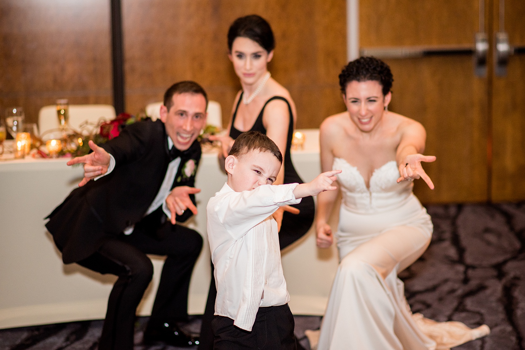 W Hoboken wedding photos at this New Jersey hotel overlooking the Manhattan skyline. Photos by Mikkel Paige Photography of the ring bearer doing Spiderman with his aunts and uncle at the reception. #mikkelpaige #HobokenWedding #NewJerseyPhotographer #NewYorkCityPhotographer #NYCweddingphotographer #brideandgroomphotos #redpeonies #romanticwedding #springwedding #CityWedding