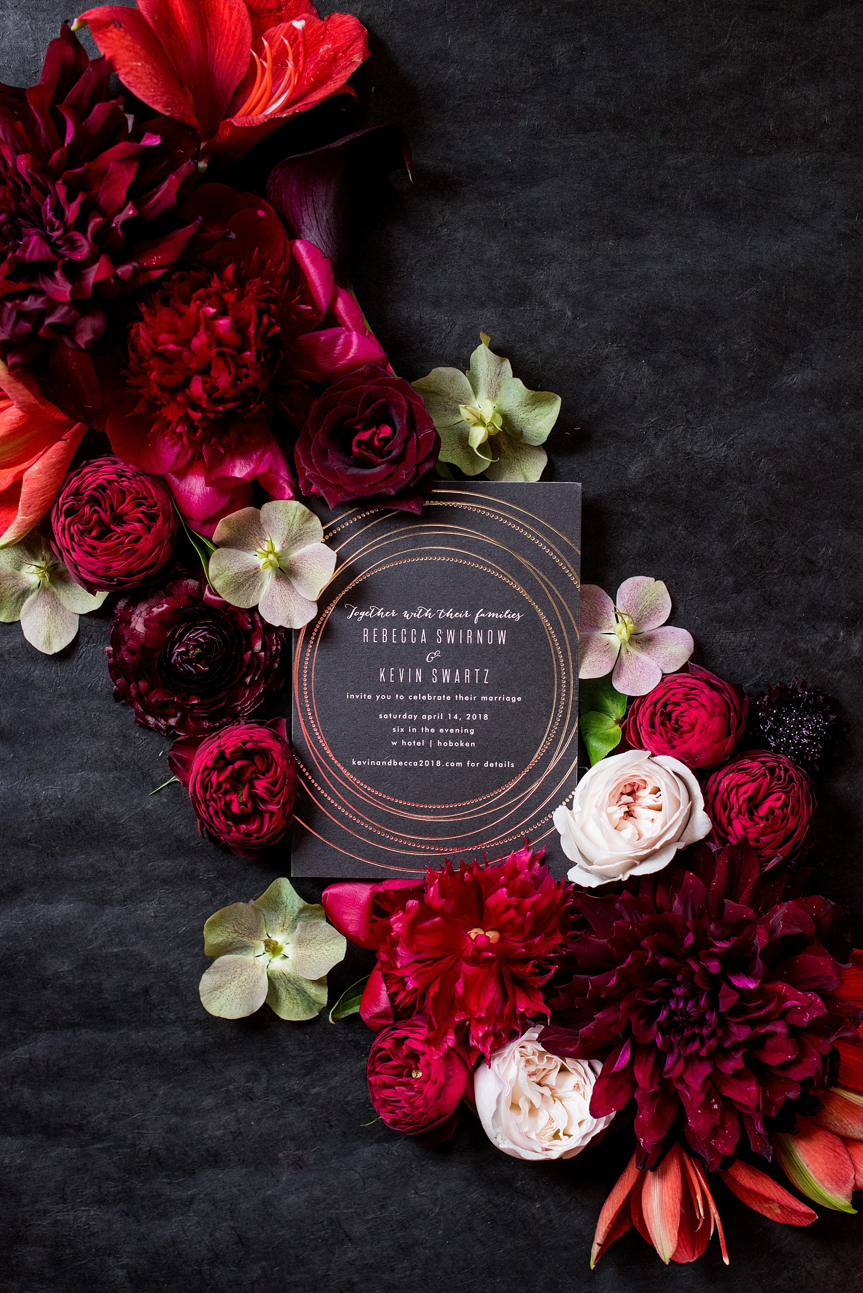 W Hoboken Wedding Photos by Mikkel Paige Photography. Spring wedding overlooking the NYC skyline, with a sexy black, deep red, burgundy and fuchsia color palette. Photo fo the bride and groom's black and gold invitation with red flowers. #HobokenWedding #mikkelpaige #springwedding #romanticwedding #NewJerseyWeddingPhotos