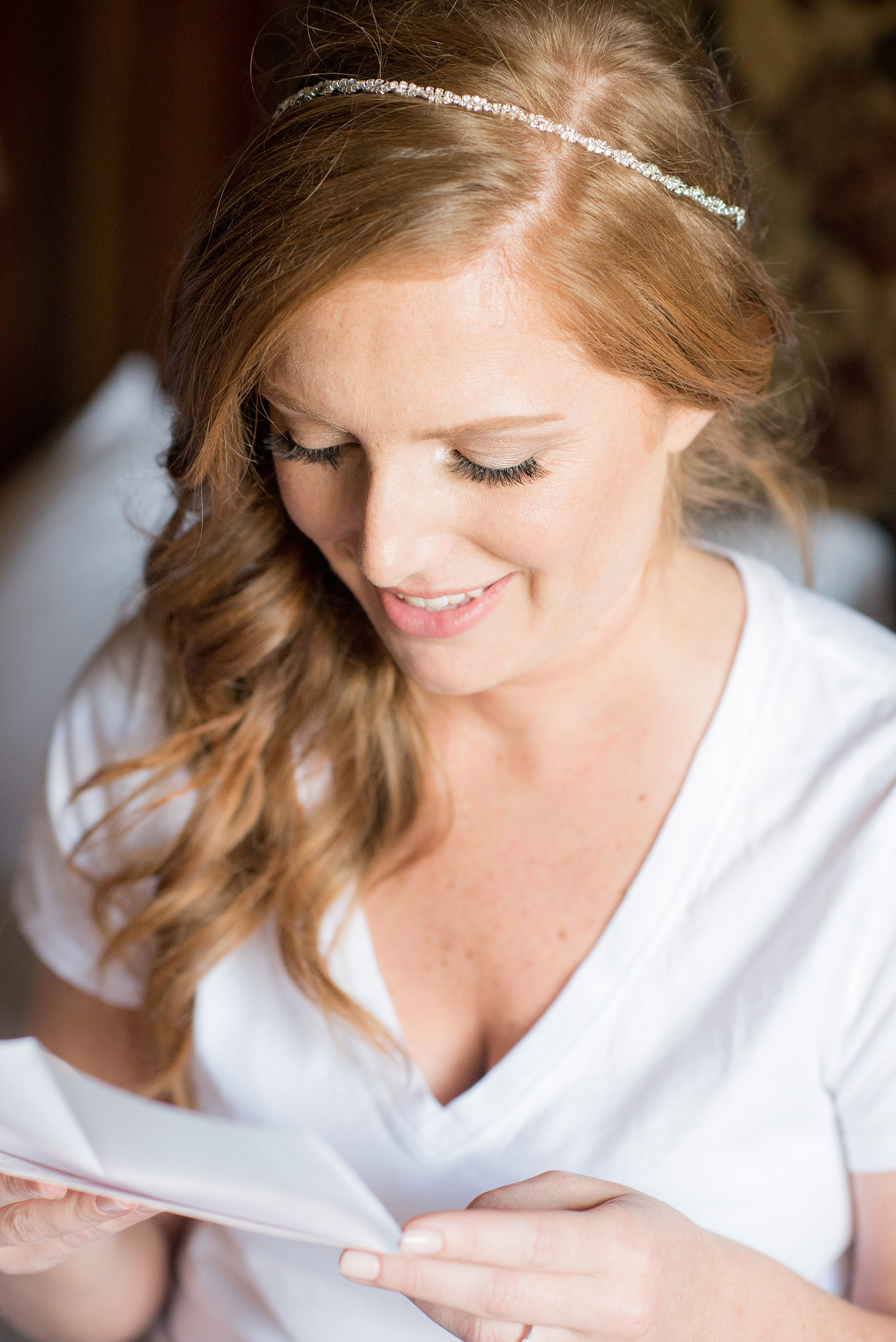 Crystal Springs Resort wedding photos in New Jersey, with photographer Mikkel Paige Photography. The couple’s spring wedding had an outdoor ceremony with photos at this rustic, woodsy venue showing their blue and pink palette decor from getting ready to their reception. This picture shows the bride opening a special gift from her groom. Click through to see their complete wedding recap! #NewJerseywedding #MikkelPaige #NJweddingphotographer #NJphotographer 