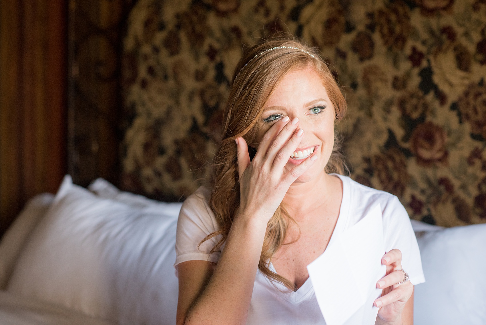 Crystal Springs Resort wedding photos in New Jersey, with photographer Mikkel Paige Photography. The couple’s spring wedding had an outdoor ceremony with photos at this rustic, woodsy venue showing their blue and pink palette decor from getting ready to their reception. This picture shows the bride crying after opening a special gift from her groom. Click through to see their complete wedding recap! #NewJerseywedding #MikkelPaige #NJweddingphotographer #NJphotographer #weddinggift 