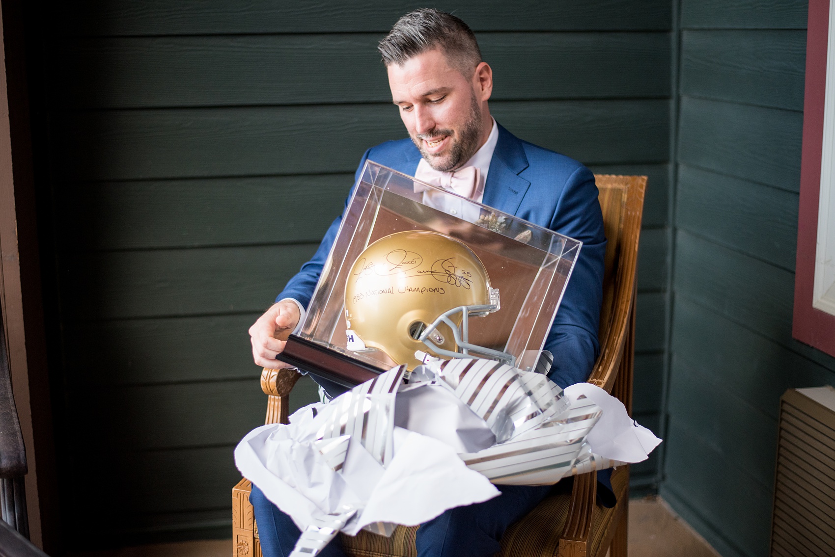 Crystal Springs Resort wedding photos in New Jersey, with photographer Mikkel Paige Photography. The couple’s spring wedding had an outdoor ceremony with photos at this rustic, woodsy venue showing their blue and pink palette decor from getting ready to their reception. This picture shows the groom opening a special gift from his bride: a signed helmet from Notre Dame football team. Click through to see their complete wedding recap! #NewJerseywedding #MikkelPaige #NJweddingphotographer #NJphotographer #NotreDame #GroomsGift #GroomGift