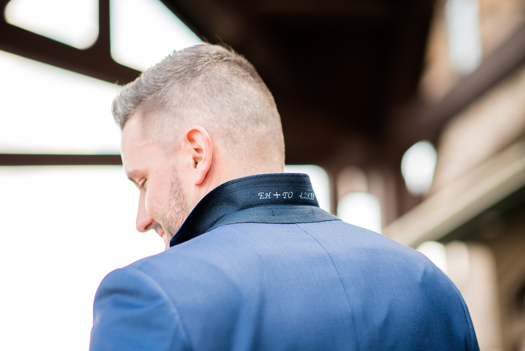 Crystal Springs Resort wedding photos in New Jersey, with photographer Mikkel Paige Photography. The couple’s spring wedding had an outdoor ceremony with photos at this rustic, woodsy venue showing their blue and pink palette decor from getting ready to their reception. This picture shows the groom's custom navy blue suit collar with their wedding date embroidered in it. Click through to see their complete wedding recap! #NewJerseywedding #MikkelPaige #NJweddingphotographer #NJphotographer #customsuit #groom #weddingdetails