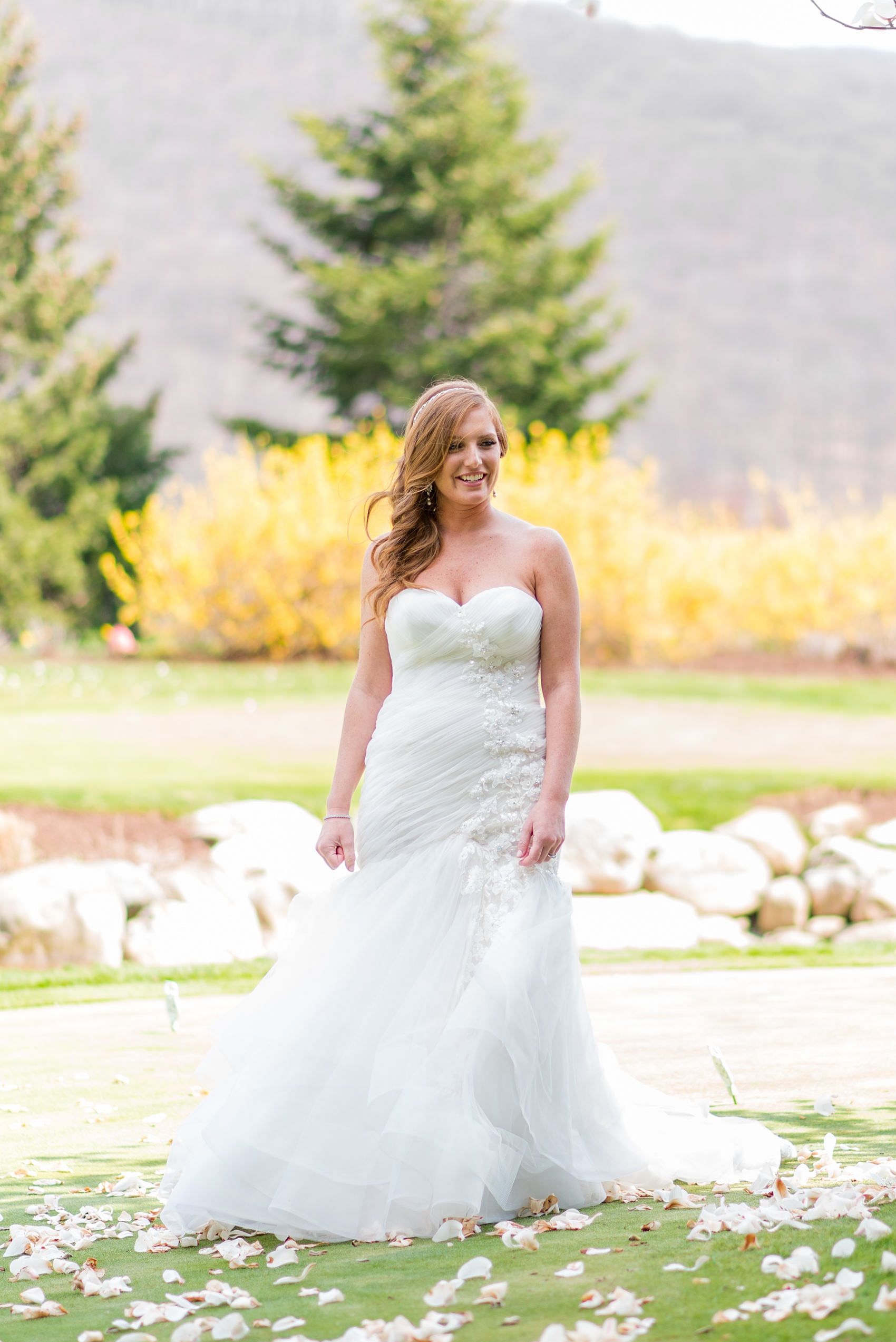 Crystal Springs Resort wedding photos in New Jersey, with photographer Mikkel Paige Photography. The couple’s spring wedding had an outdoor ceremony with photos at this rustic, woodsy venue showing their blue and pink palette decor from getting ready to their reception. This picture shows the bride in her lace gown awaiting her first look with her groom. Click through to see their complete wedding recap! #NewJerseywedding #MikkelPaige #NJweddingphotographer #NJphotographer #weddinggown #lacegown #weddingdress #gettingready