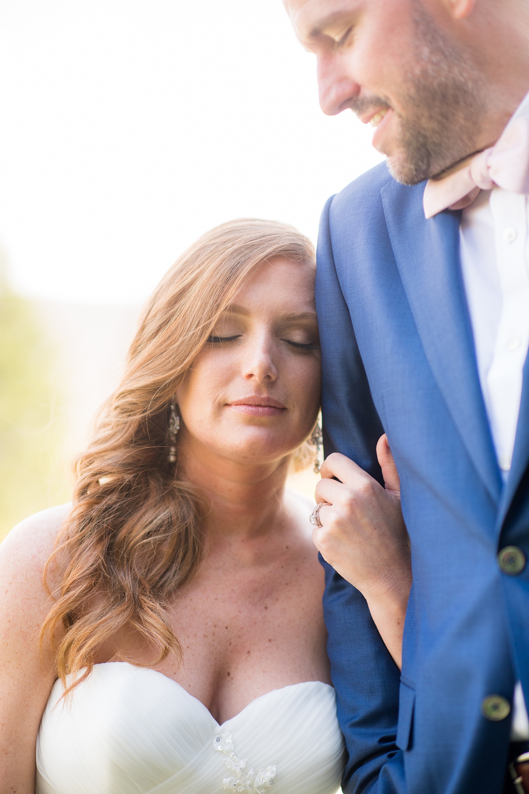Crystal Springs Resort wedding photos in New Jersey, with photographer Mikkel Paige Photography. The couple’s spring wedding had an outdoor ceremony with photos at this rustic, woodsy venue showing their blue and pink palette decor from getting ready to their reception. This picture shows the bride and groom in her lace gown and his navy blue suit with pink bow tie. Click through to see their complete wedding recap! #NewJerseywedding #MikkelPaige #NJweddingphotographer #NJphotographer #brideandgroom #springwedding